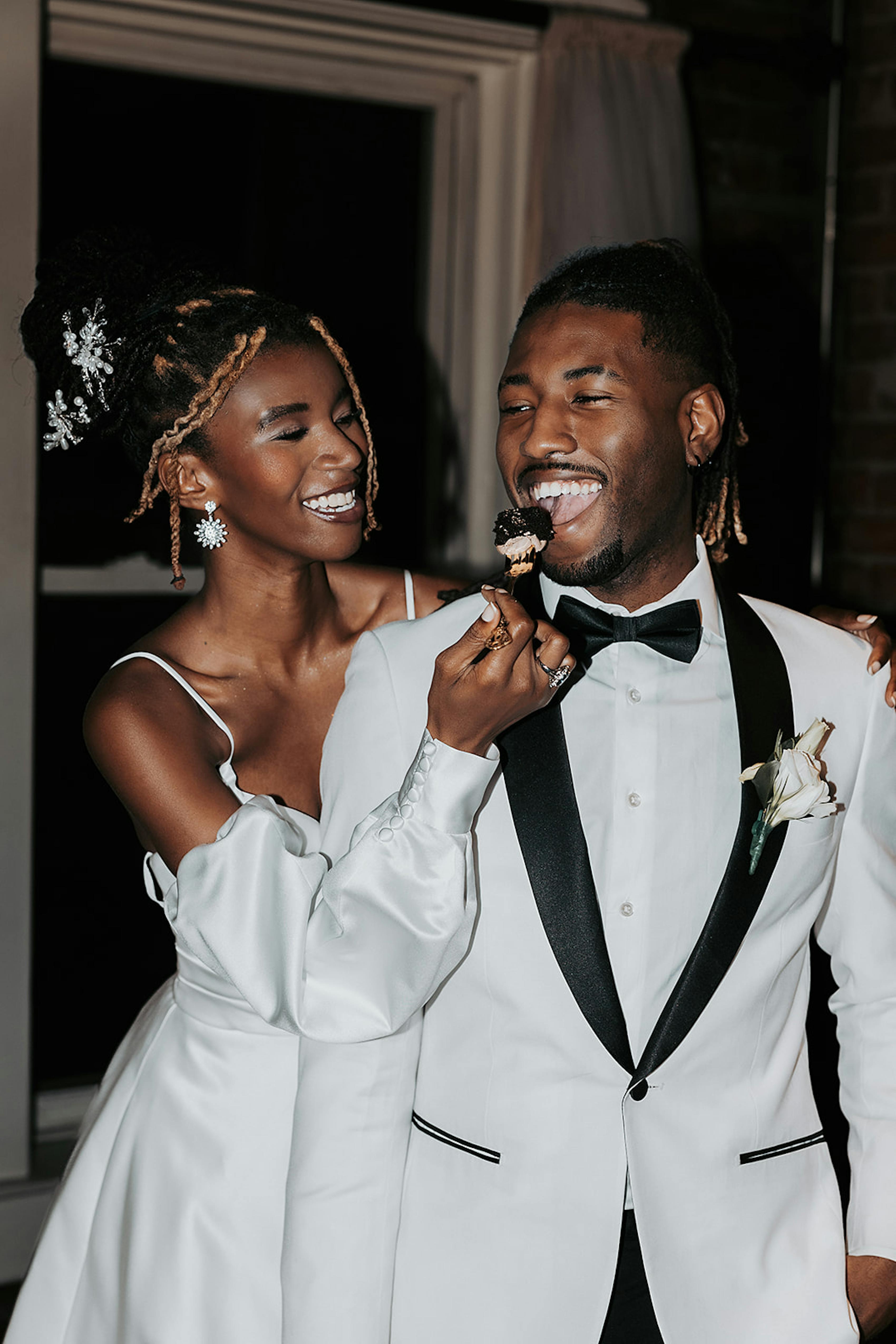 Groom's white tuxedo with black lapel for all white wedding color theme