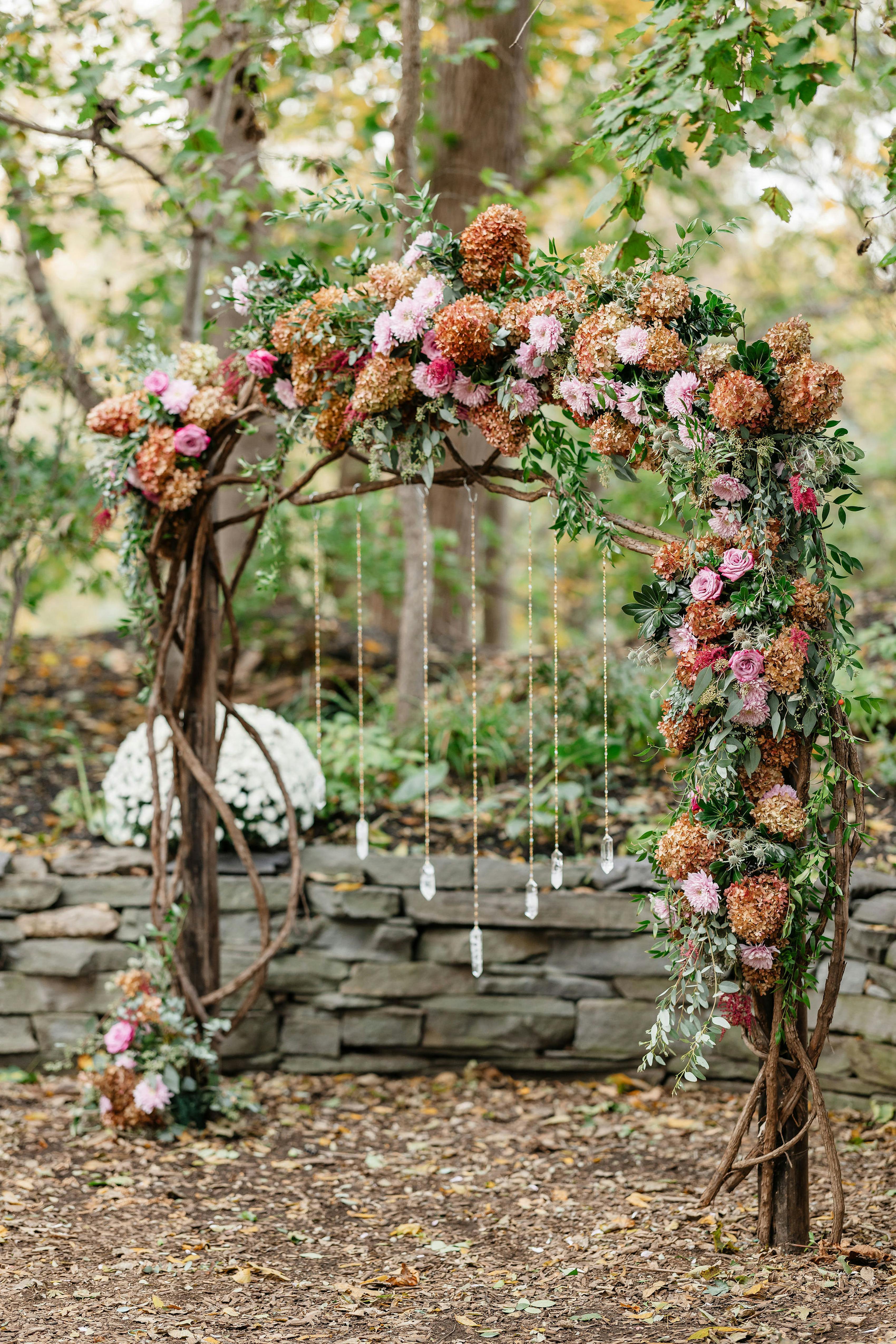 Dusty wildflower colors scheme floral wedding arch with crystals