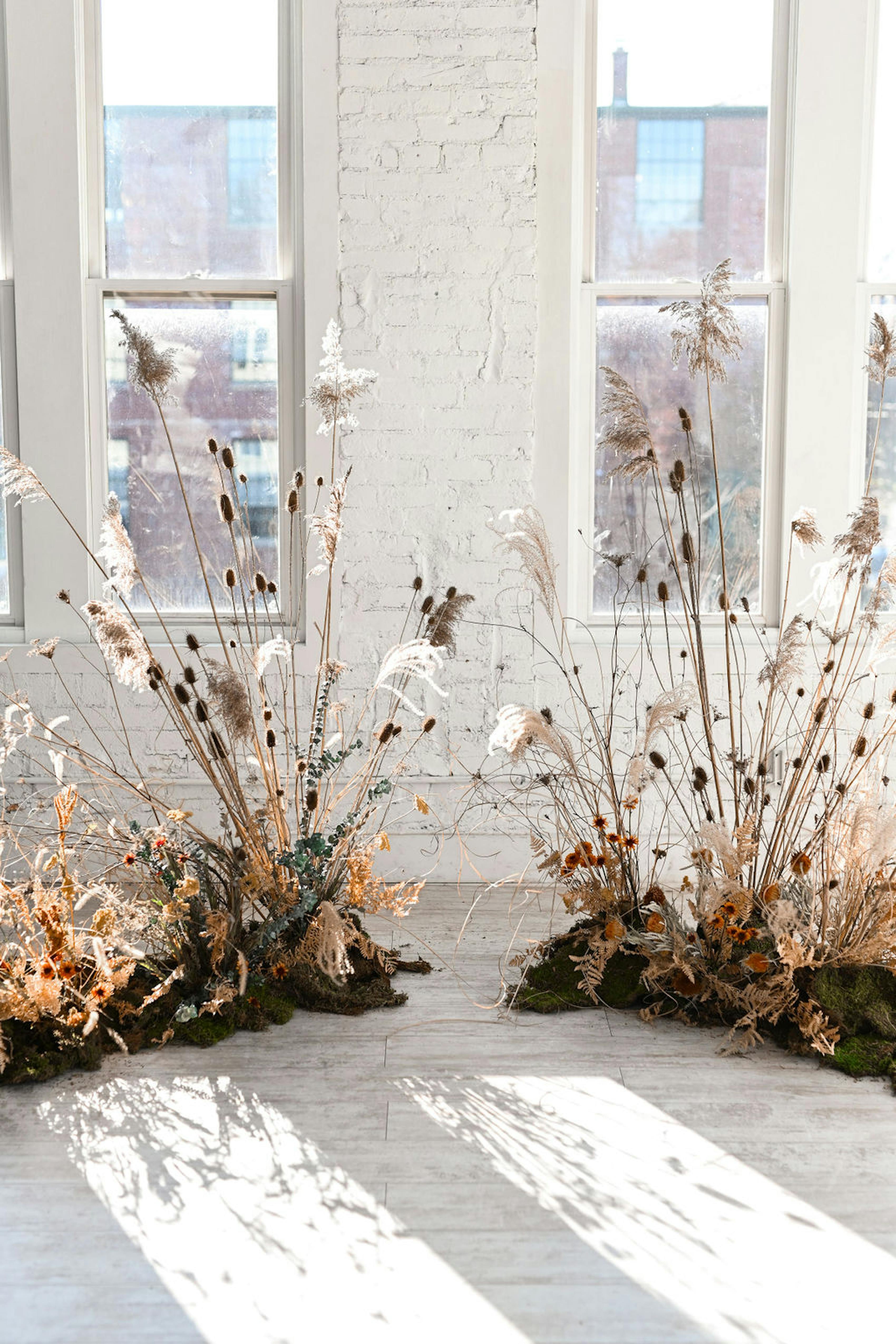 Whimsical wedding venue in art gallery with floral installation