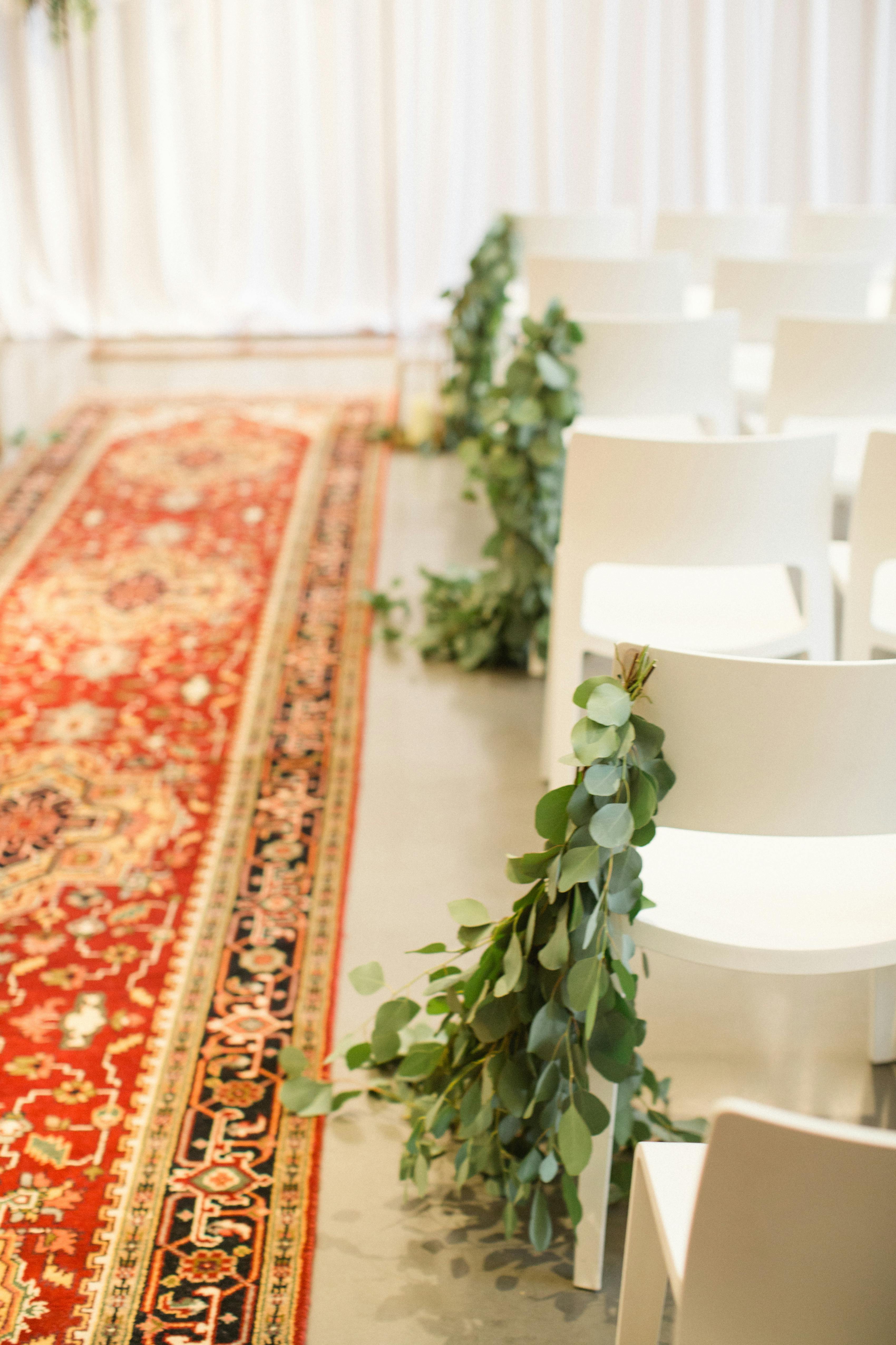 Sage wedding decor with eucalyptus-lined aisle