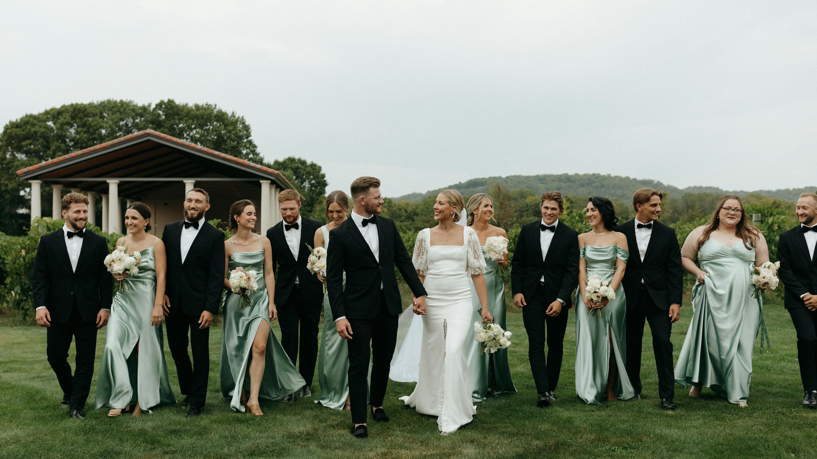 Sage bridesmaid dresses and black groomsmen tuxedos for green black tie wedding