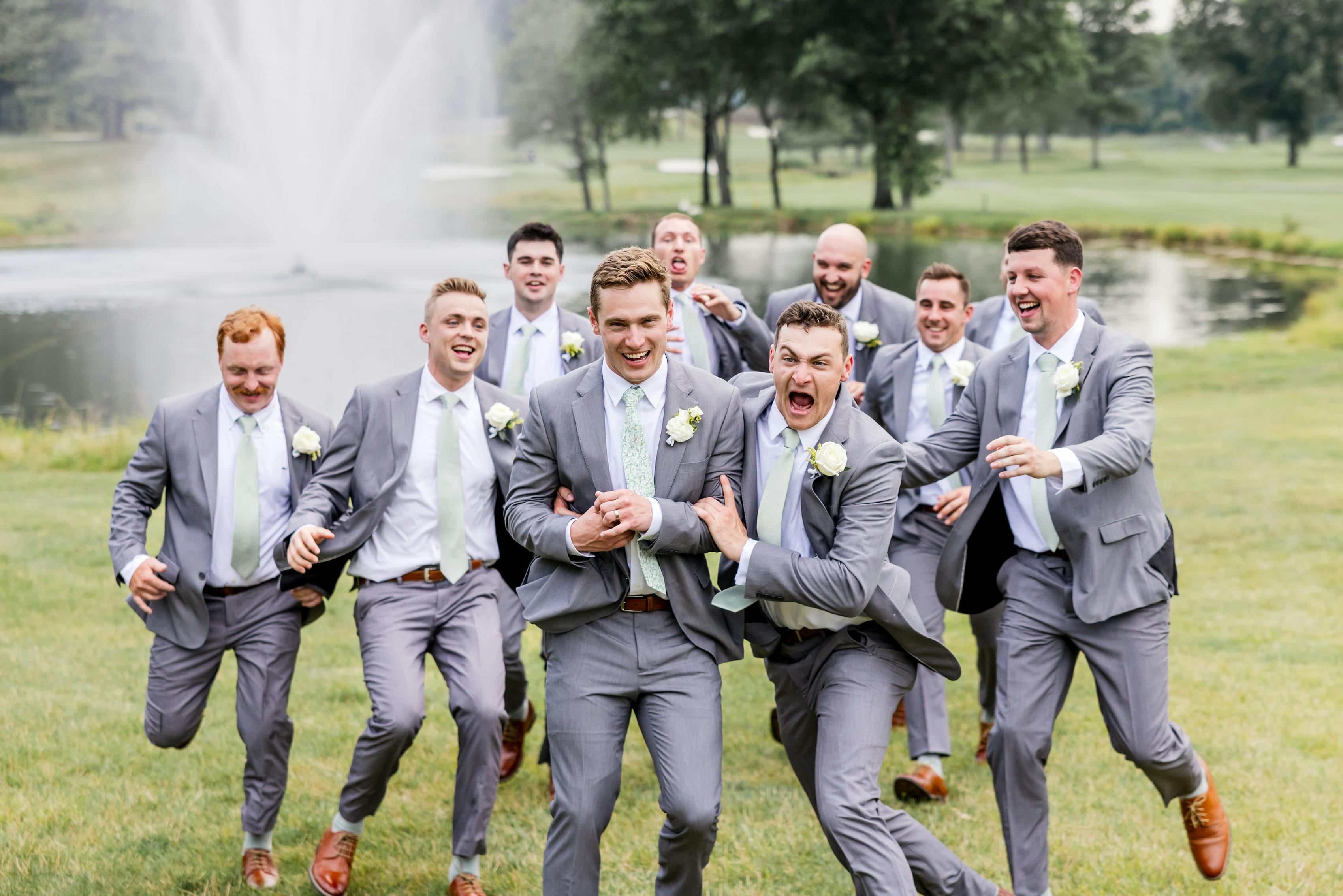 Light grey groomsmen suits at golf course wedding for bridal party attire