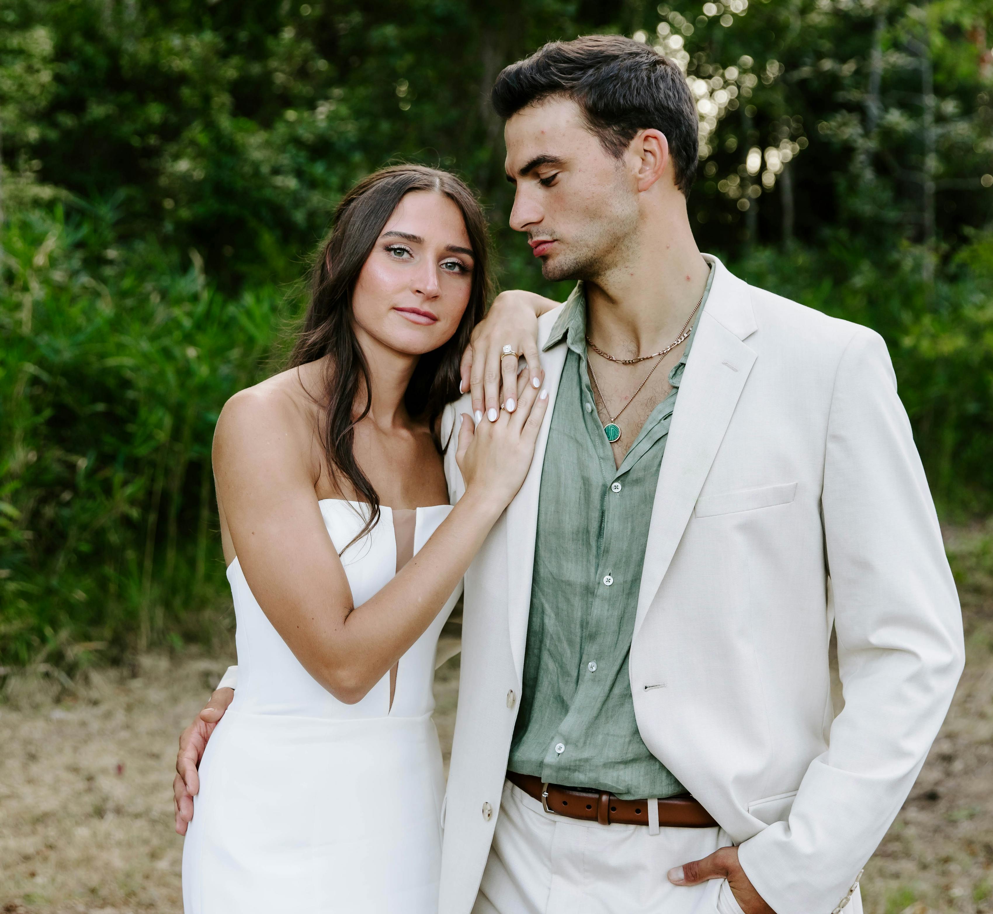 Tan suit and sage green dress shirt groom outfit for wedding
