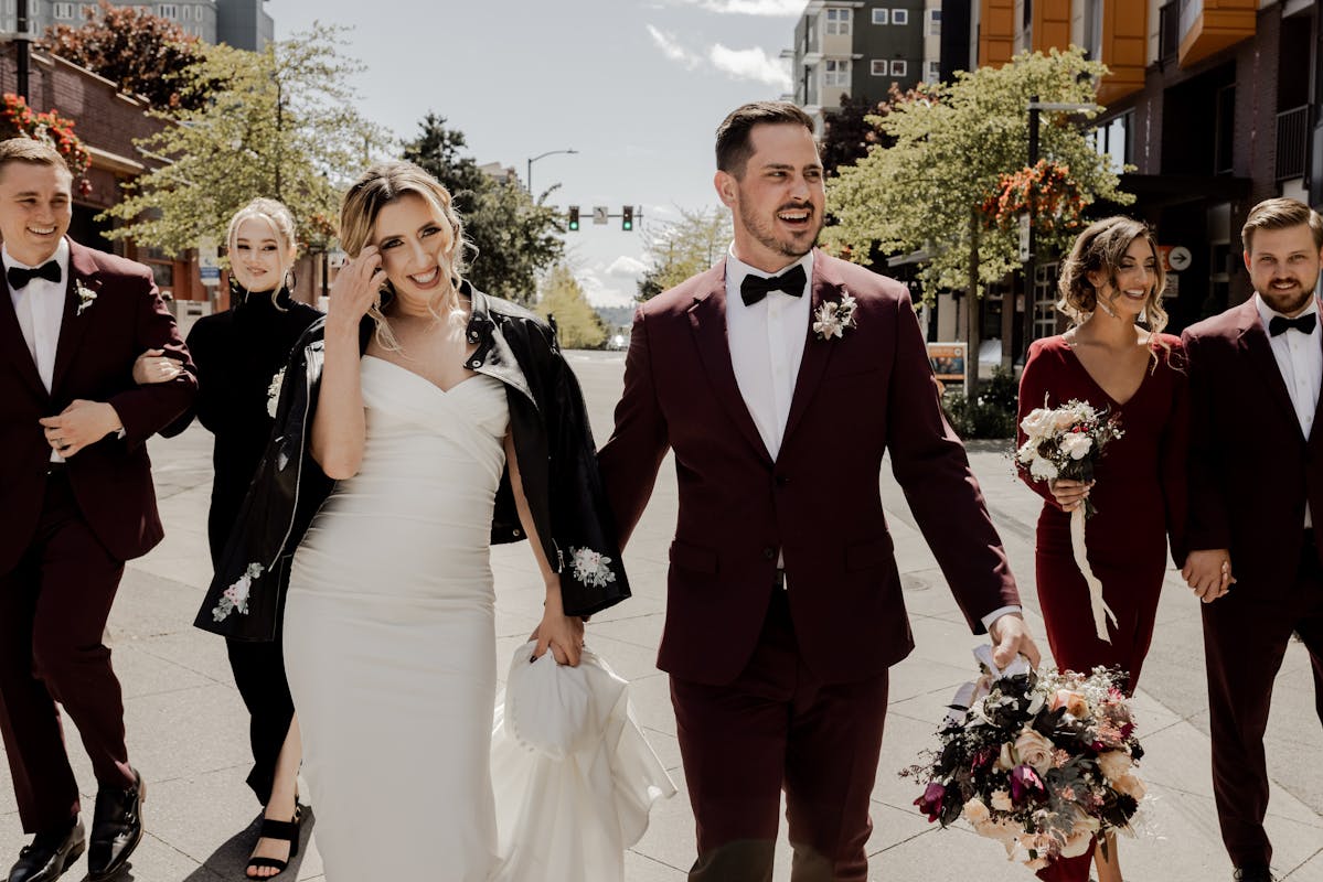 Cherry red wedding party in burgundy groomsman suits and bridesmaid dresses