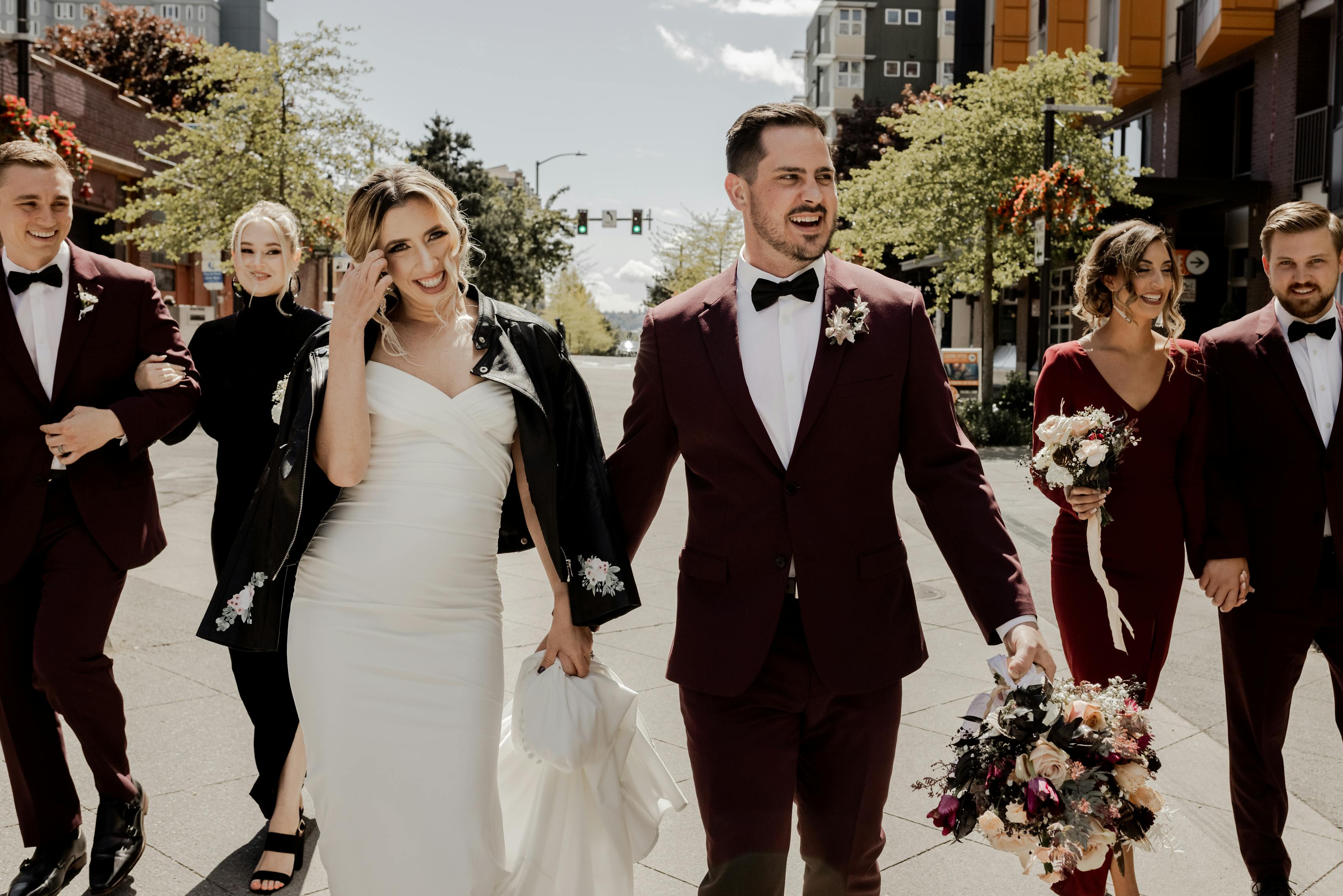 Cherry red wedding party in burgundy groomsman suits and bridesmaid dresses