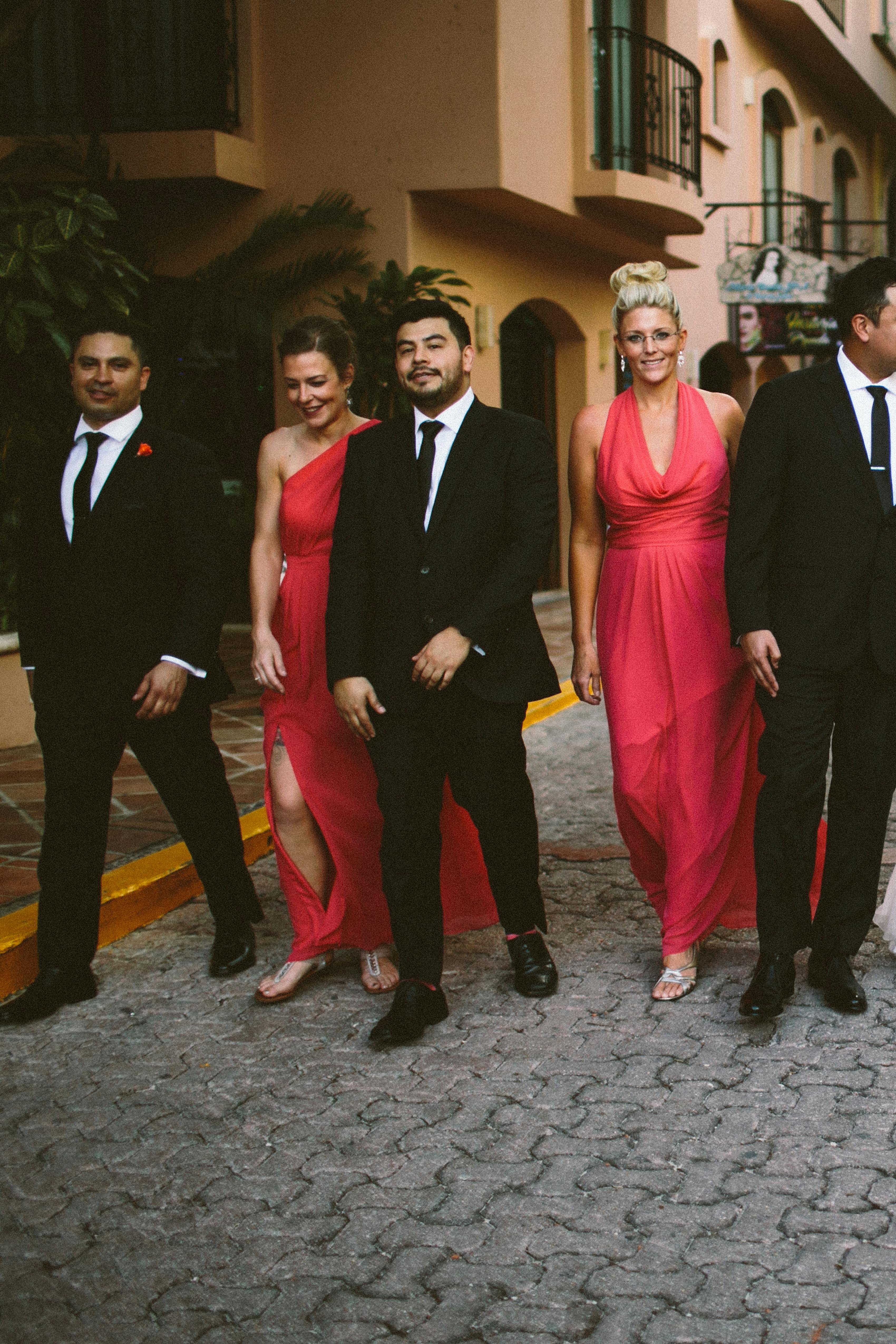 Bright red bridesmaid dresses and black groomsman suits for cherry wedding