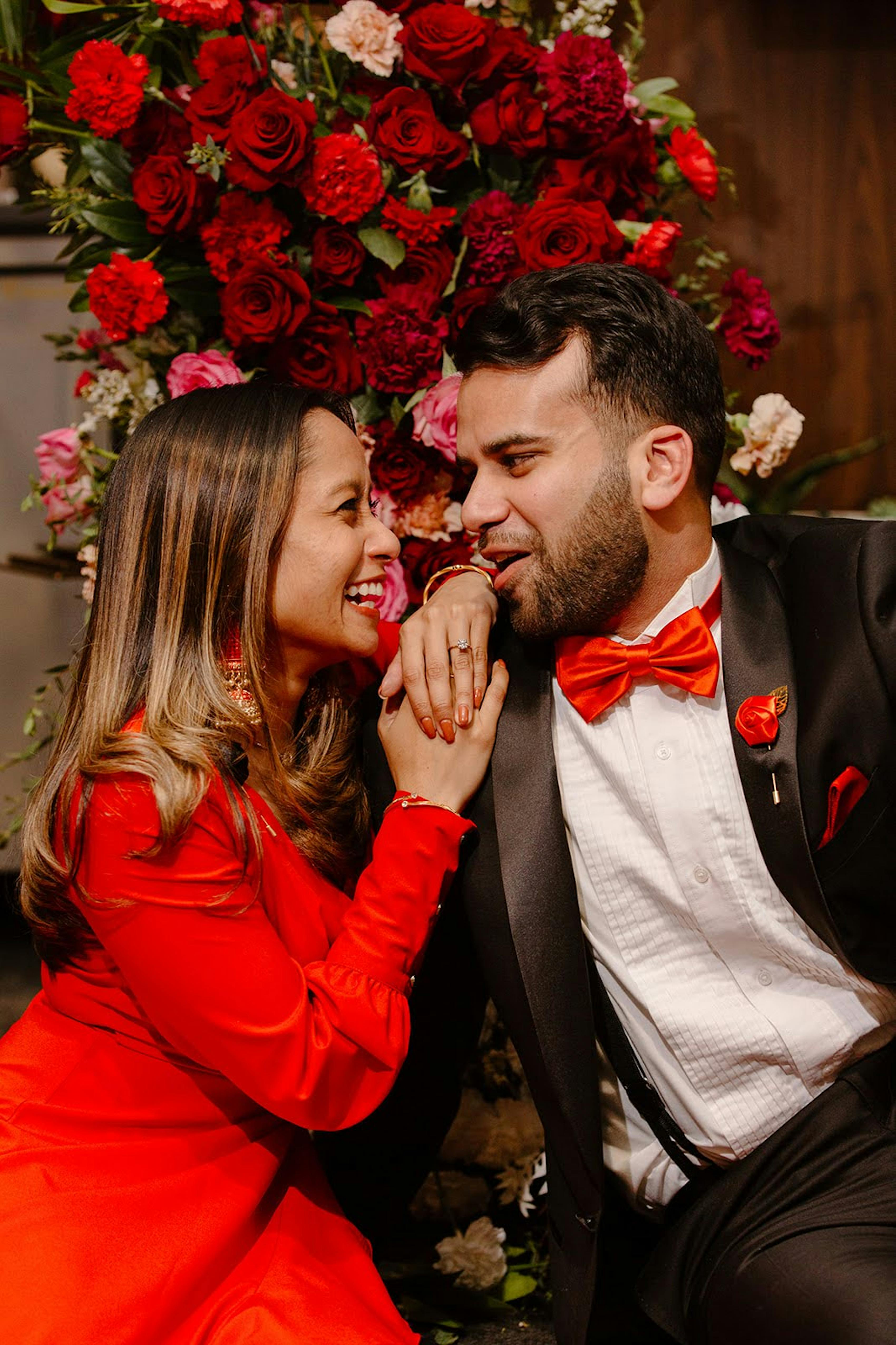 Bright red wedding with red bridal gown and black tuxedo with colorful red bow tie