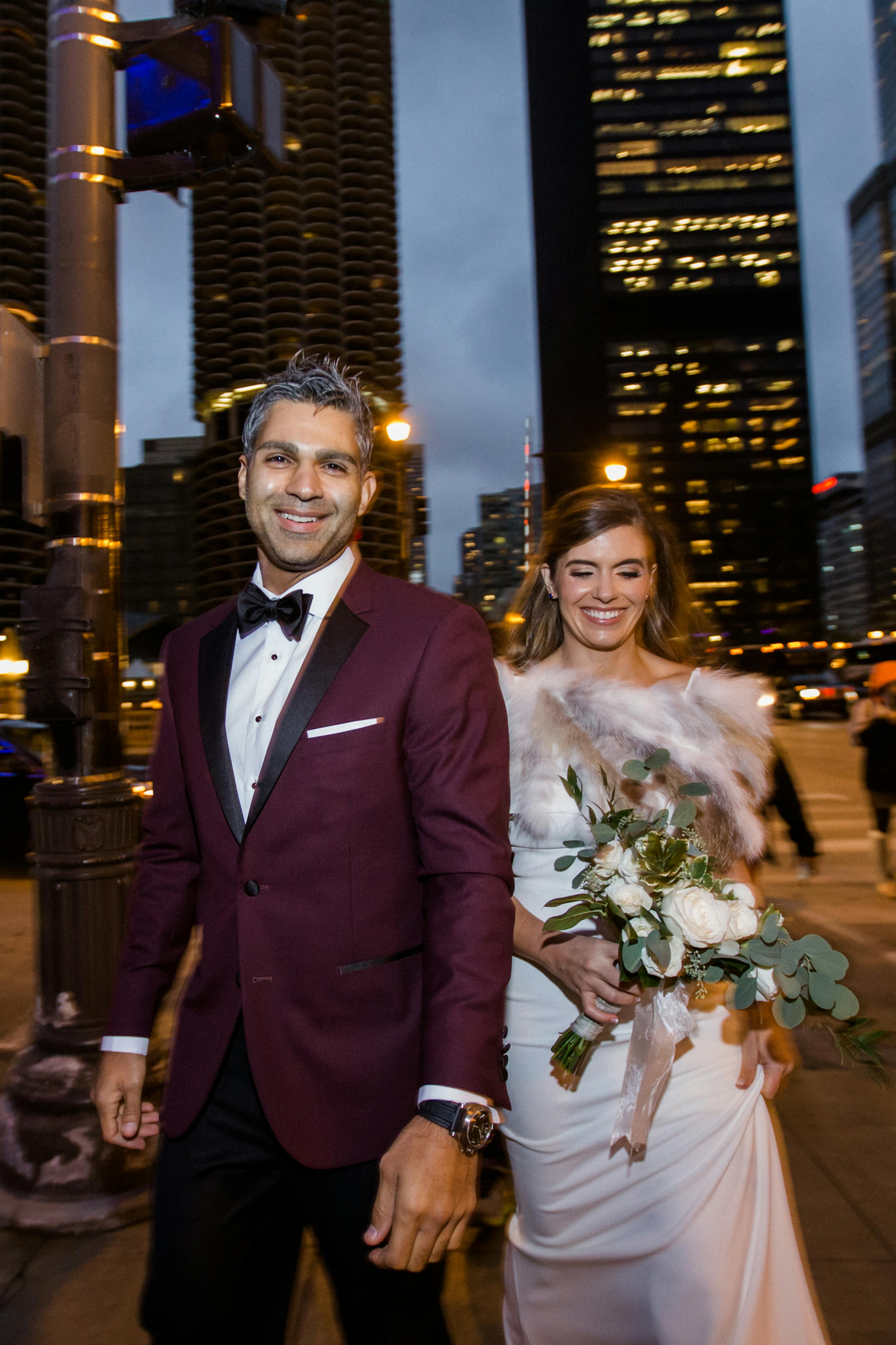 Burgundy tuxedo groom with winter bridal outfit for city wedding with red theme