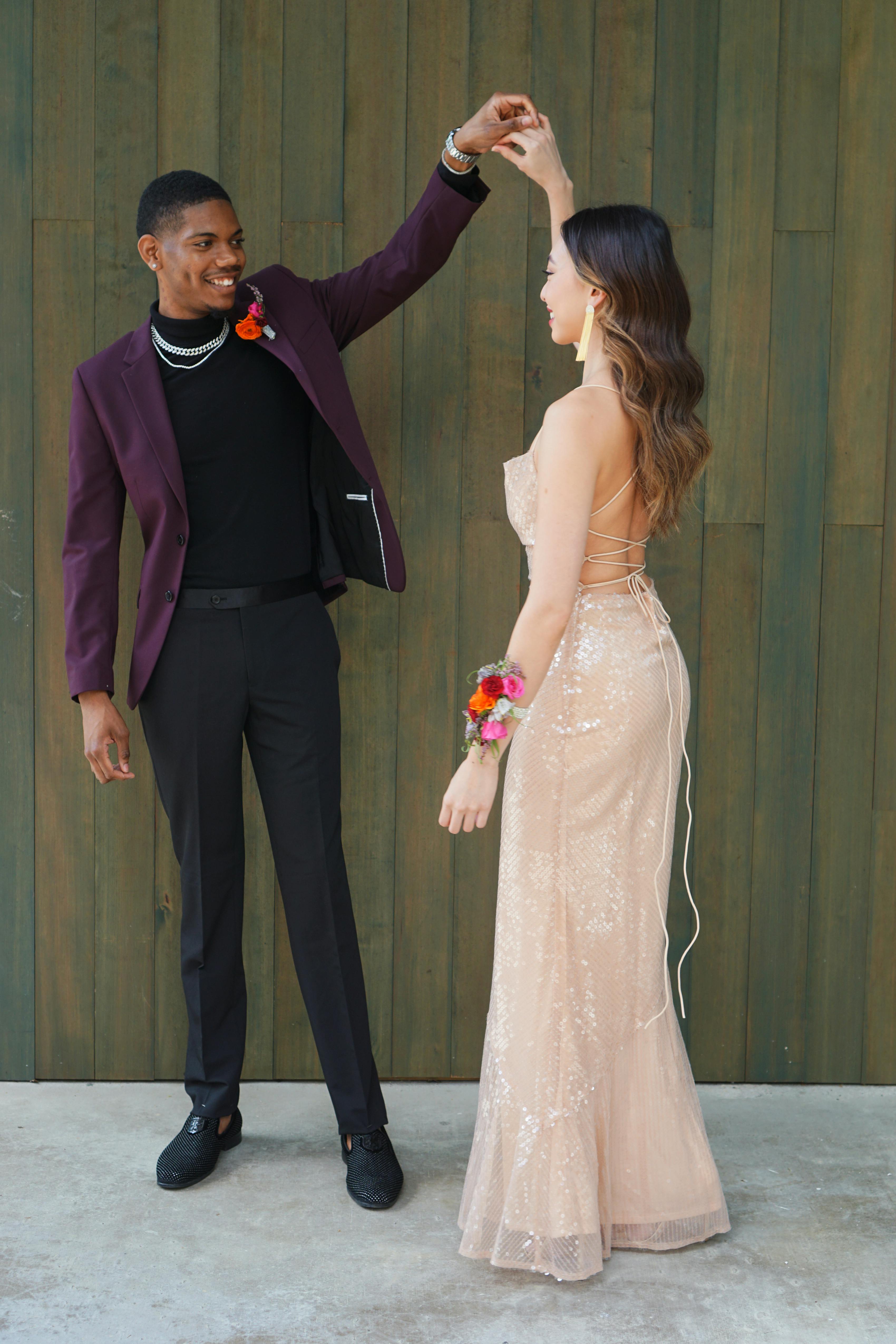 Burgundy prom suit and coordinating pink prom date dress dancing