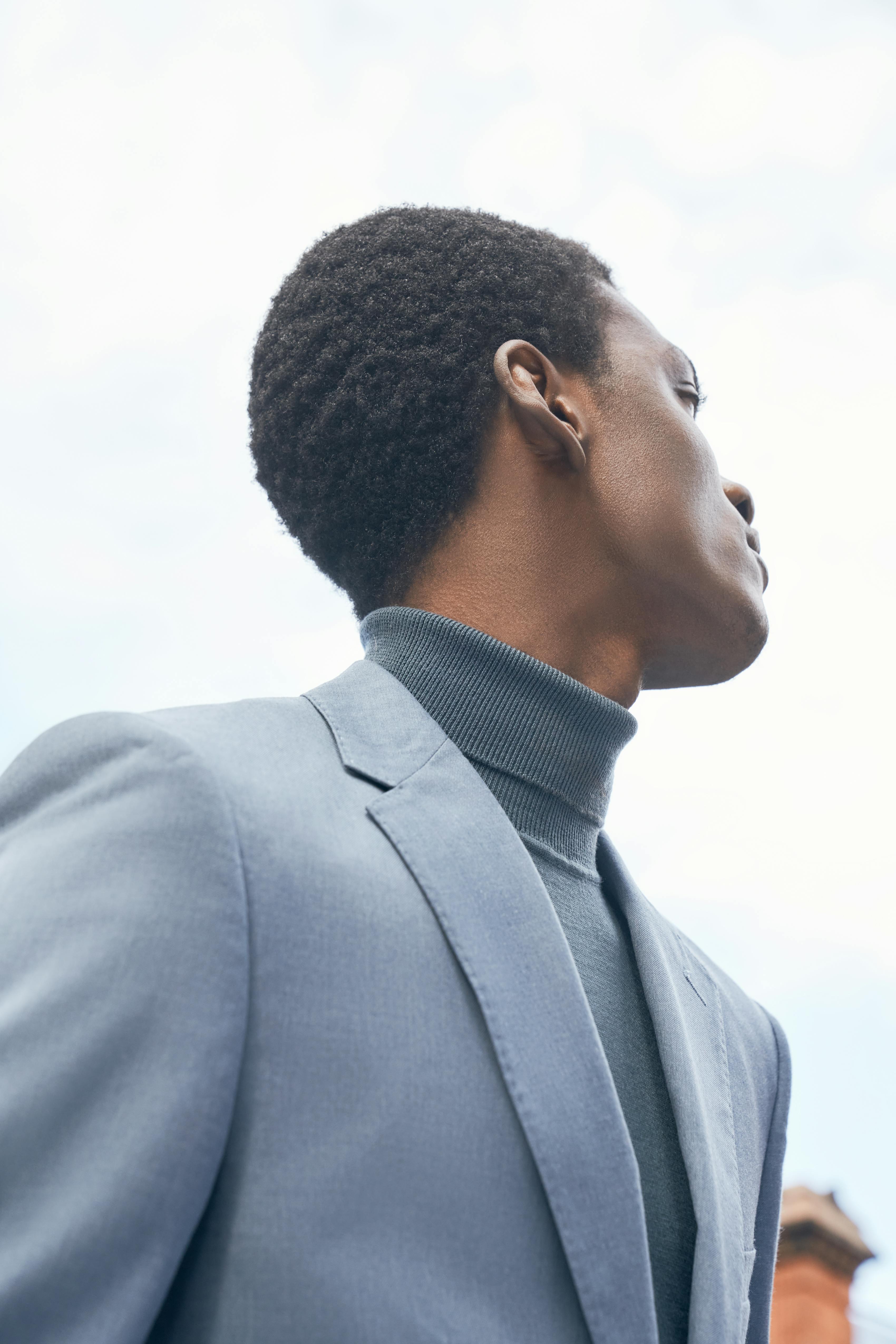 Monochrome suit styling with men's light blue blazer and turtleneck
