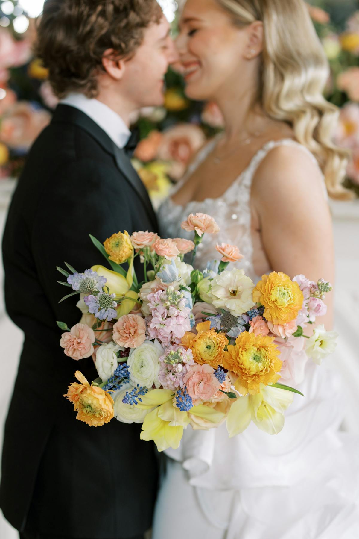 Butter yellow spring wedding bouquet with salmon pink and orange accent colors