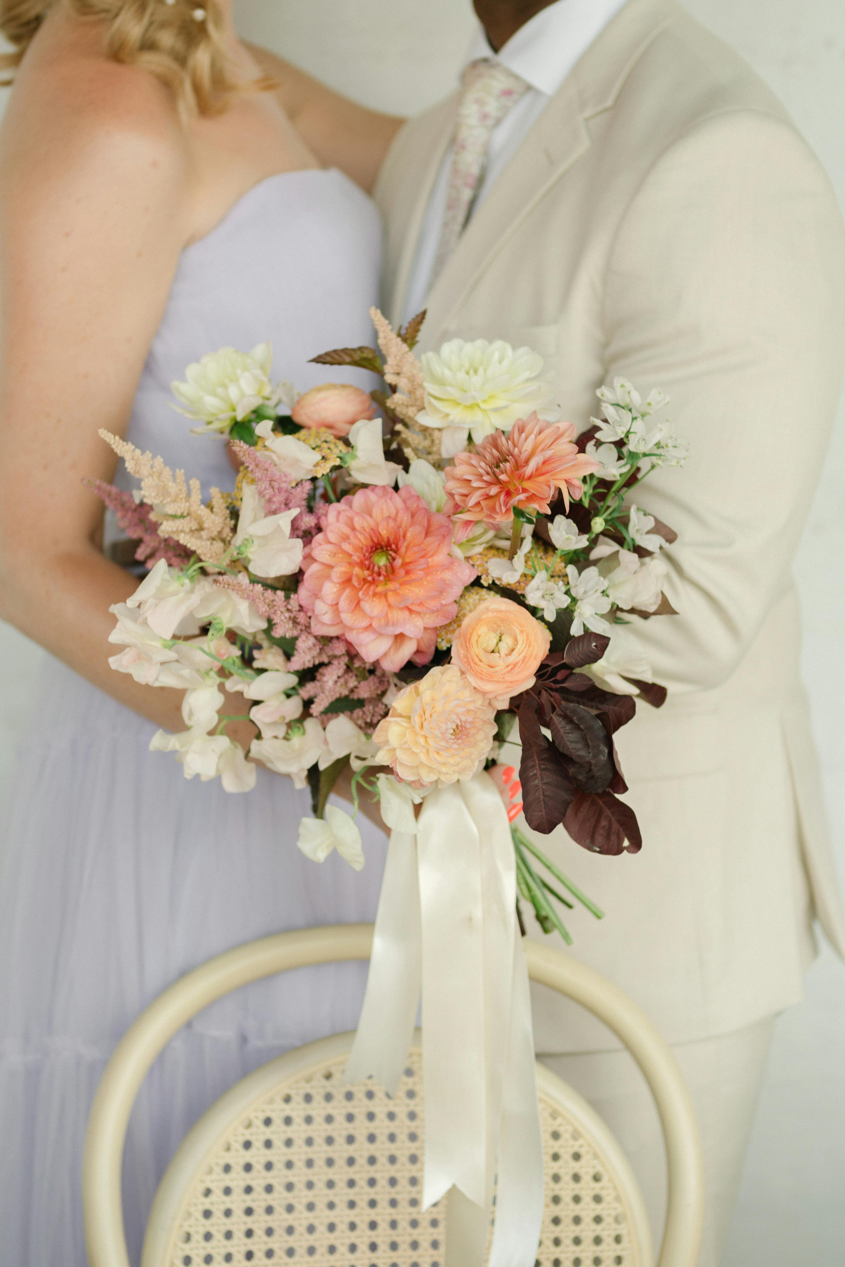 Lilac bridesmaid dress with light tan groomsman suit for spring pastel wedding