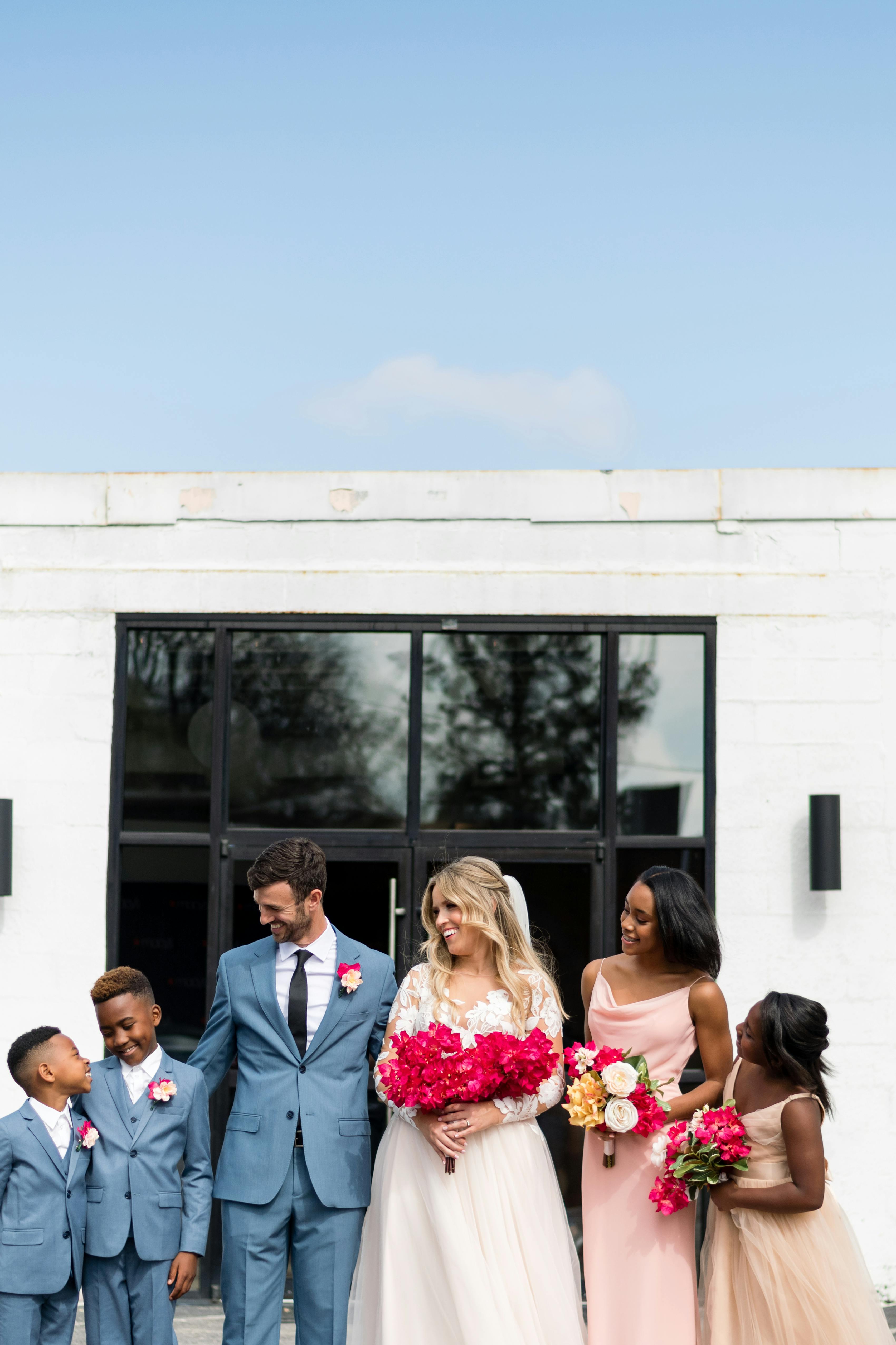 Pale blue suits for kids and groom with light pink bridesmaid dresses