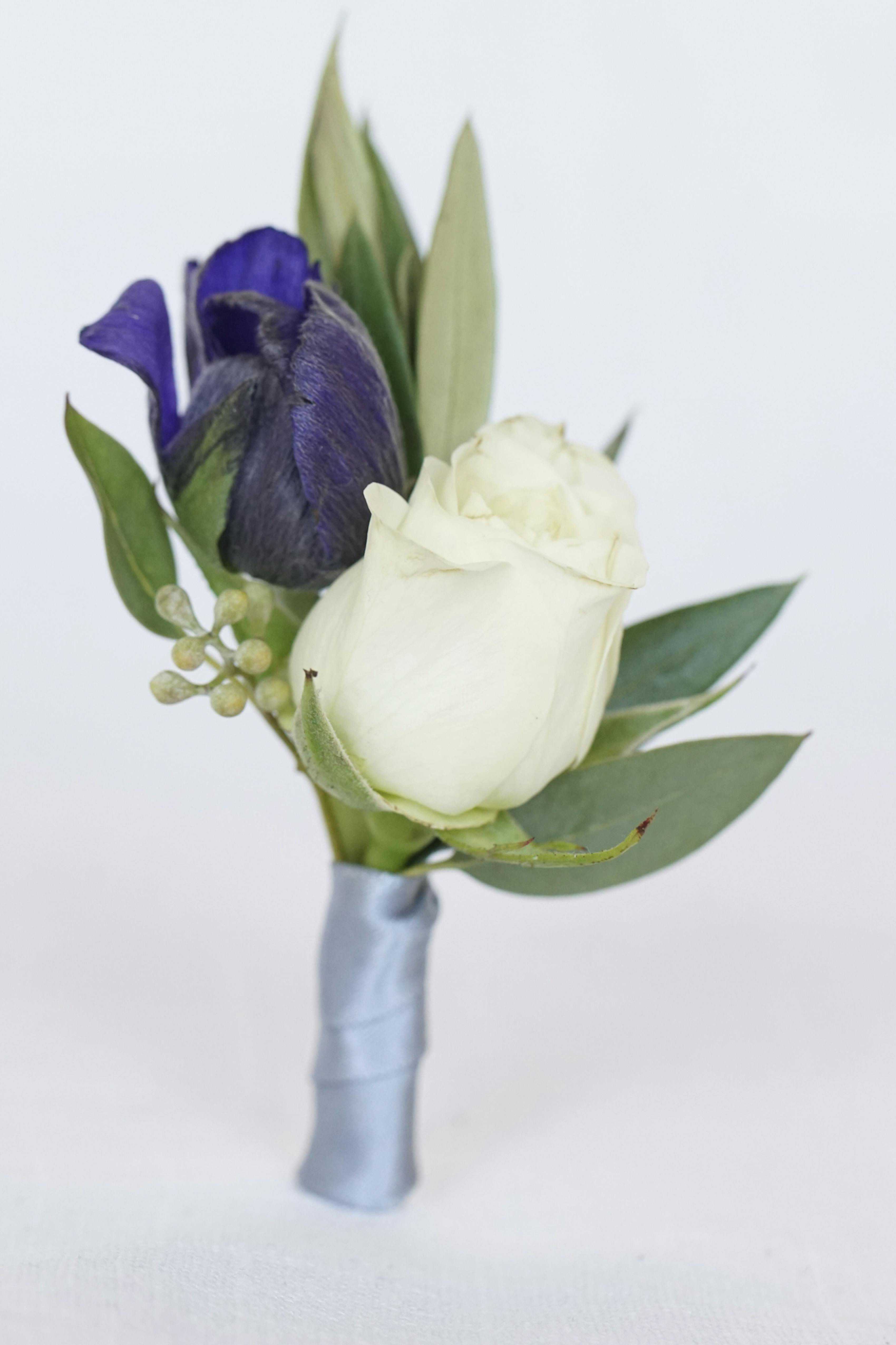 Dark lavender purple and green wedding floral arrangement boutonniere