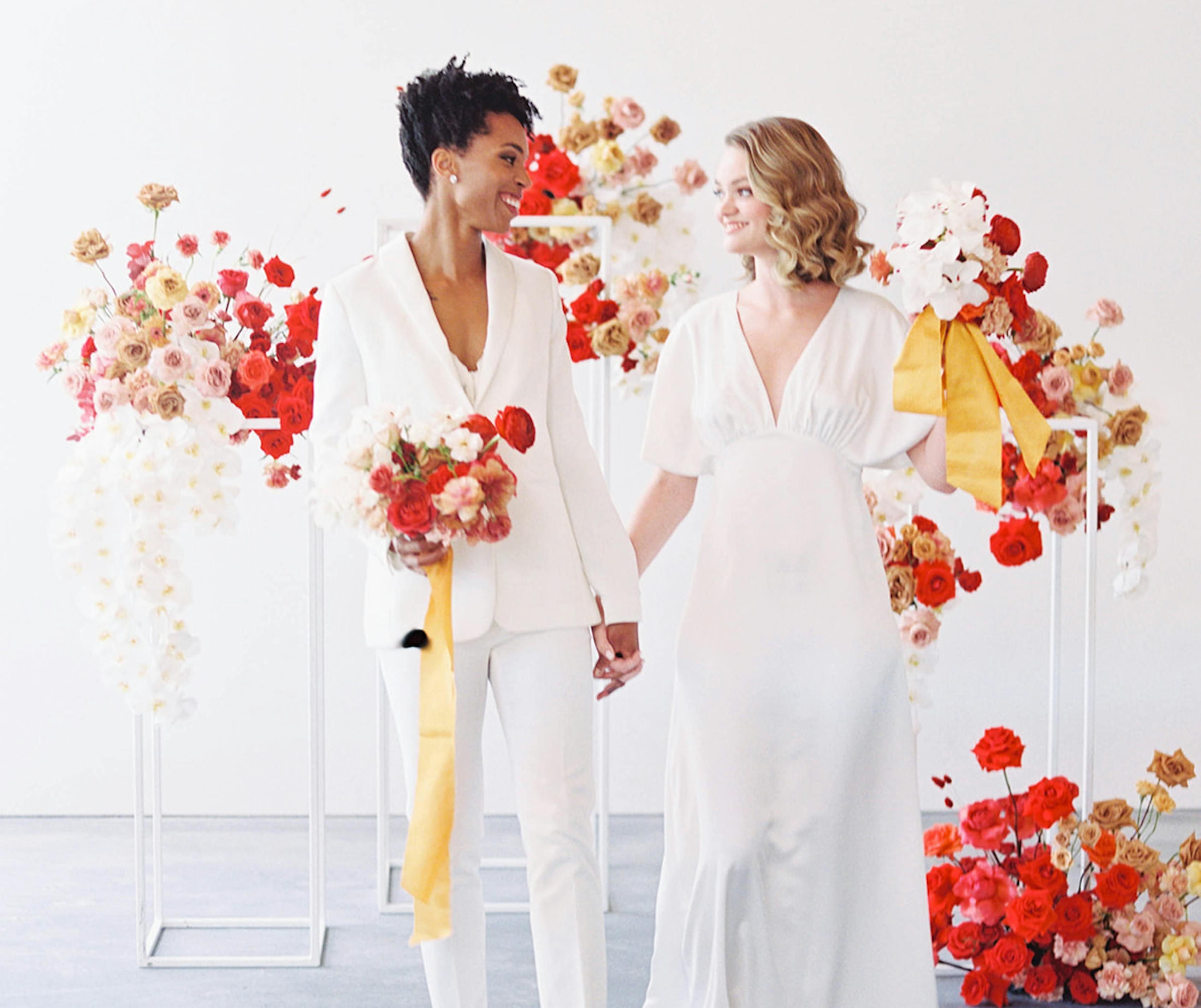 White bridal suit and dress with red and yellow wedding design