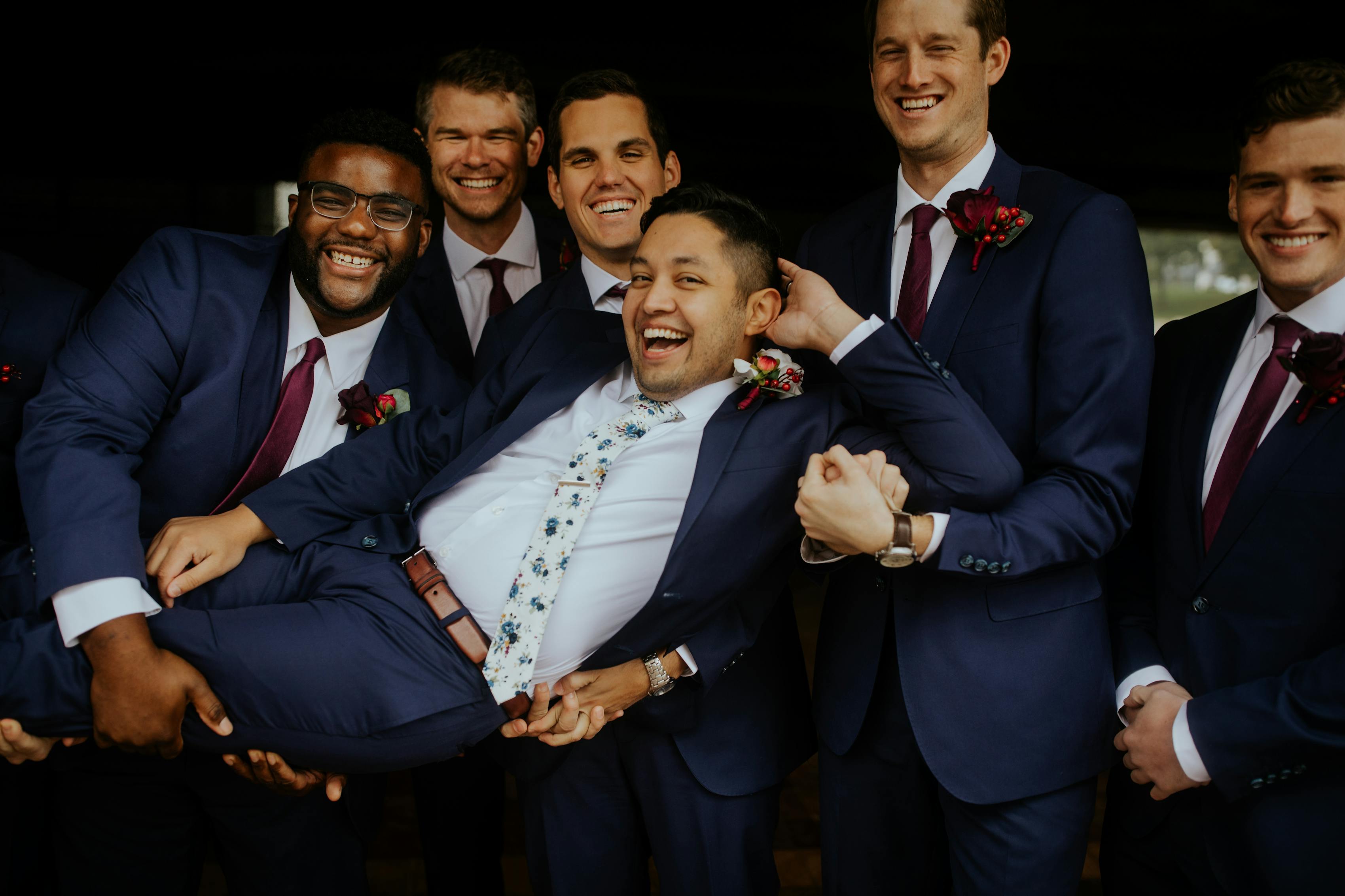 Fun wedding day groomsman pose