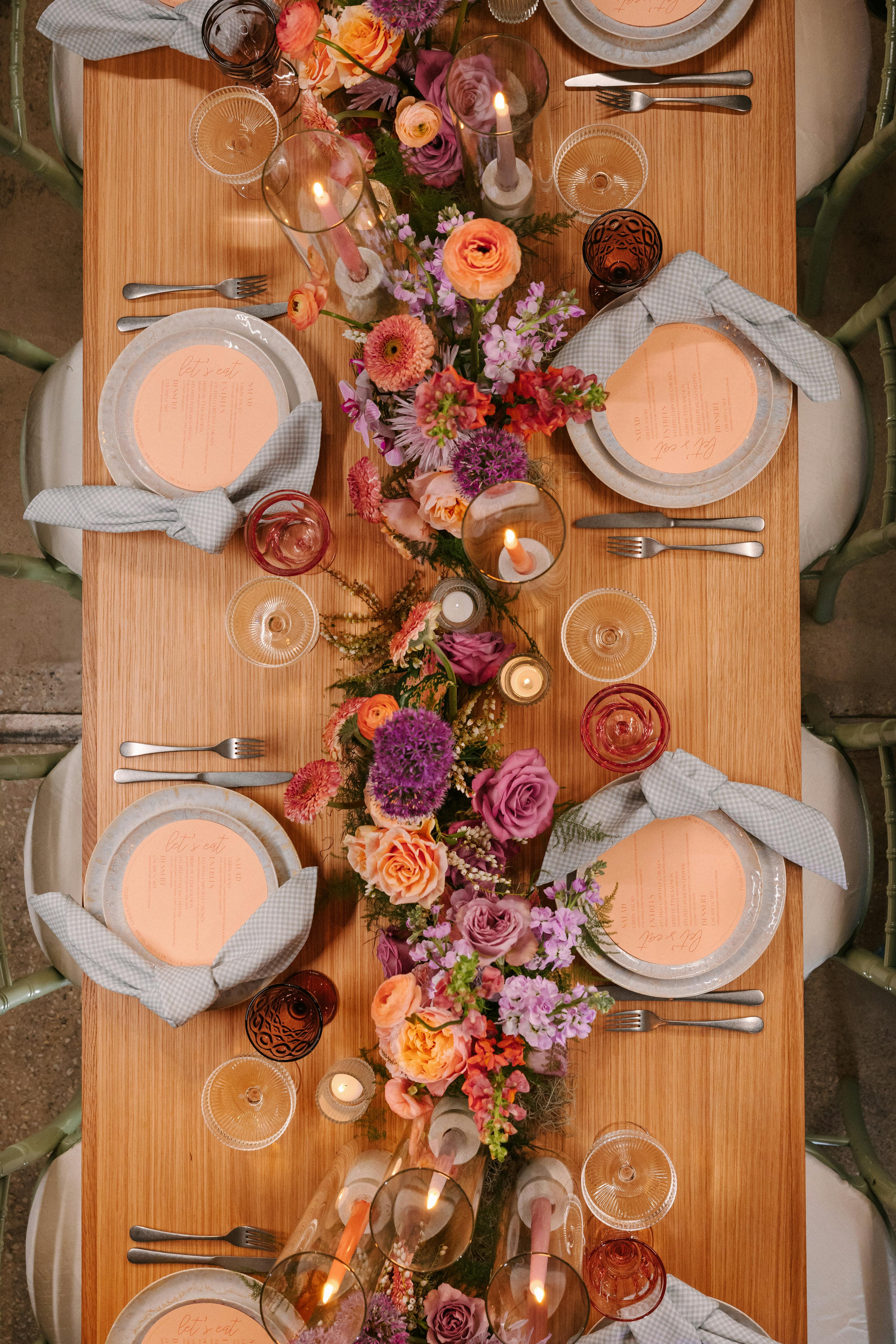 Colorful wedding tablescape design with orange and pink runner