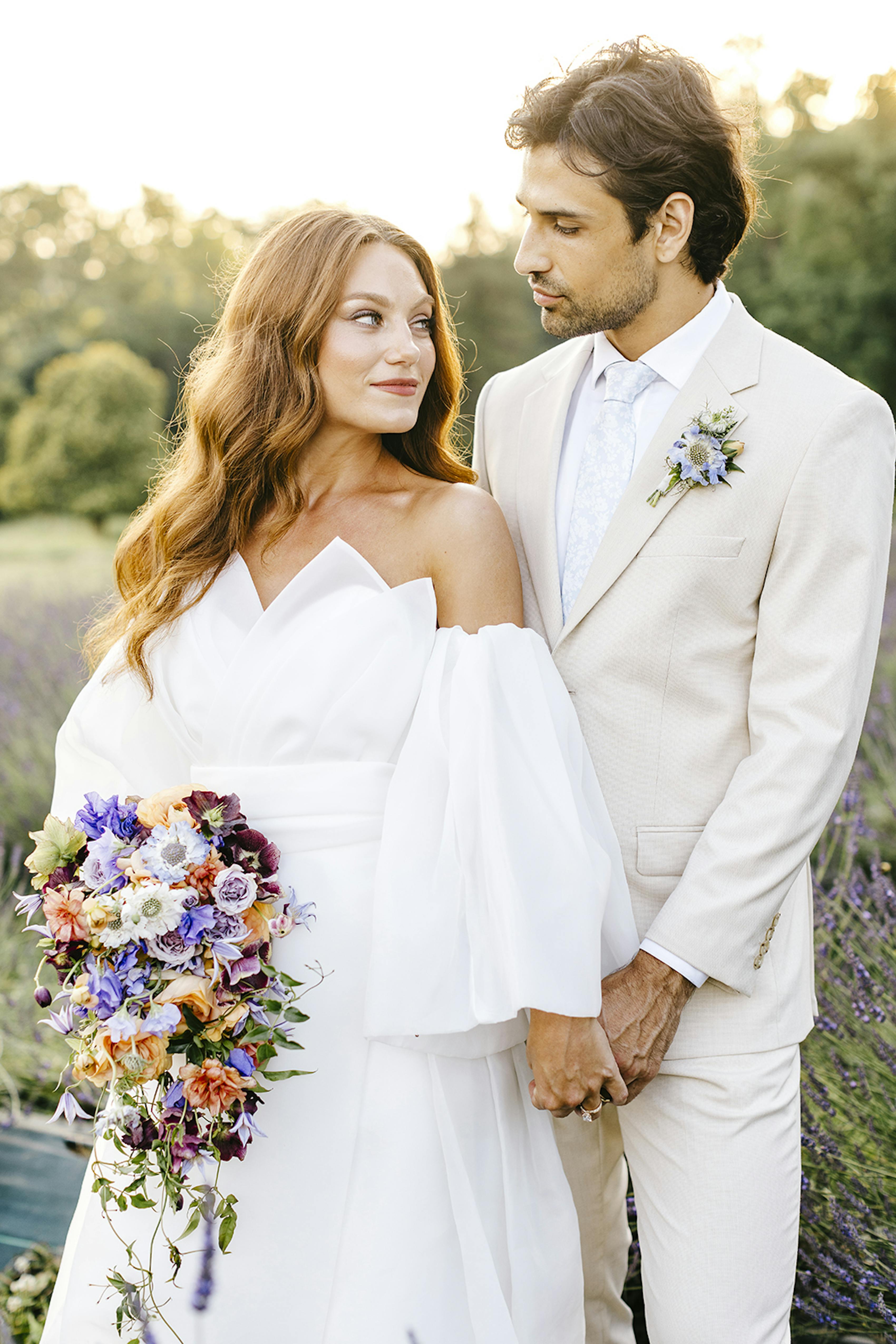 Purple and green colorful spring wedding with bold bouquet and light tan groom suit