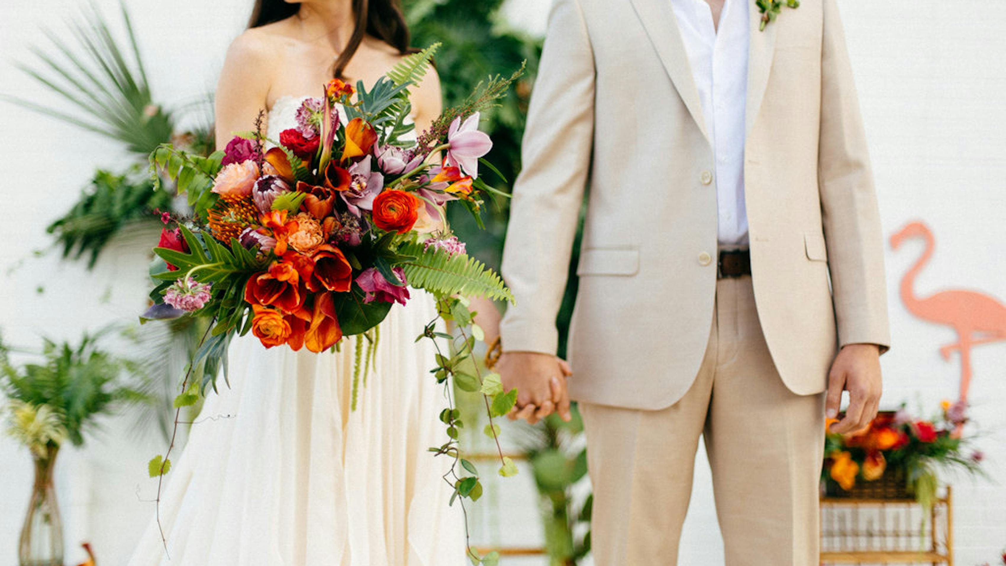 Bright wedding colors with tropical bouquet, tan suit groom, and classic bride