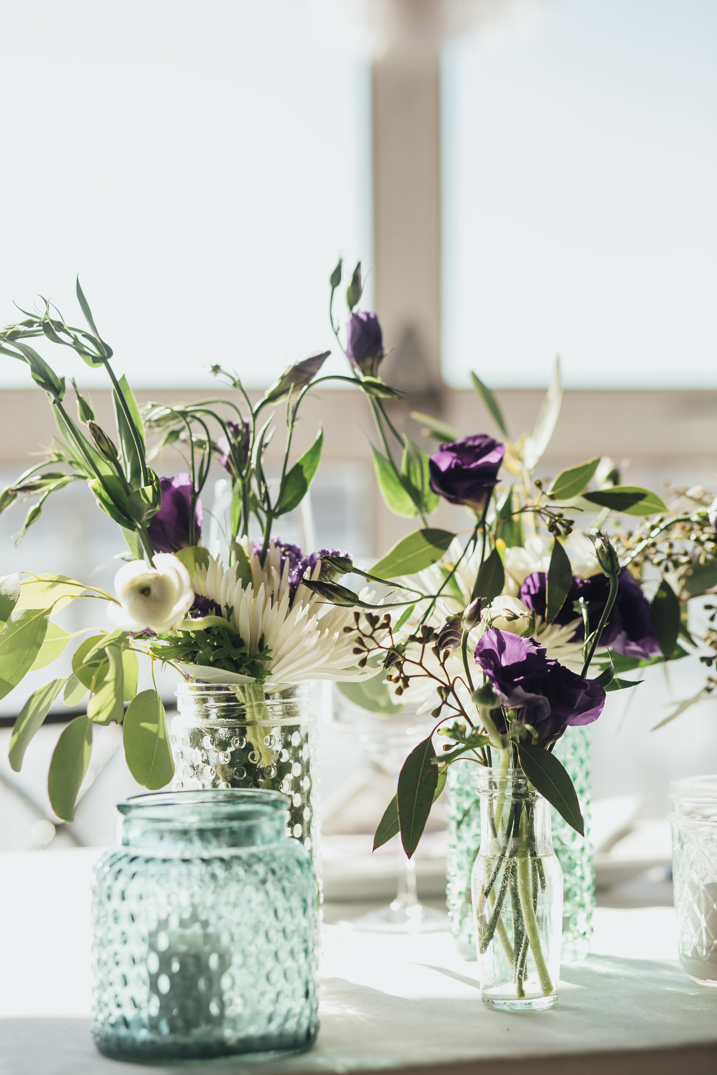 Wedding centerpieces with dark purple and green florals