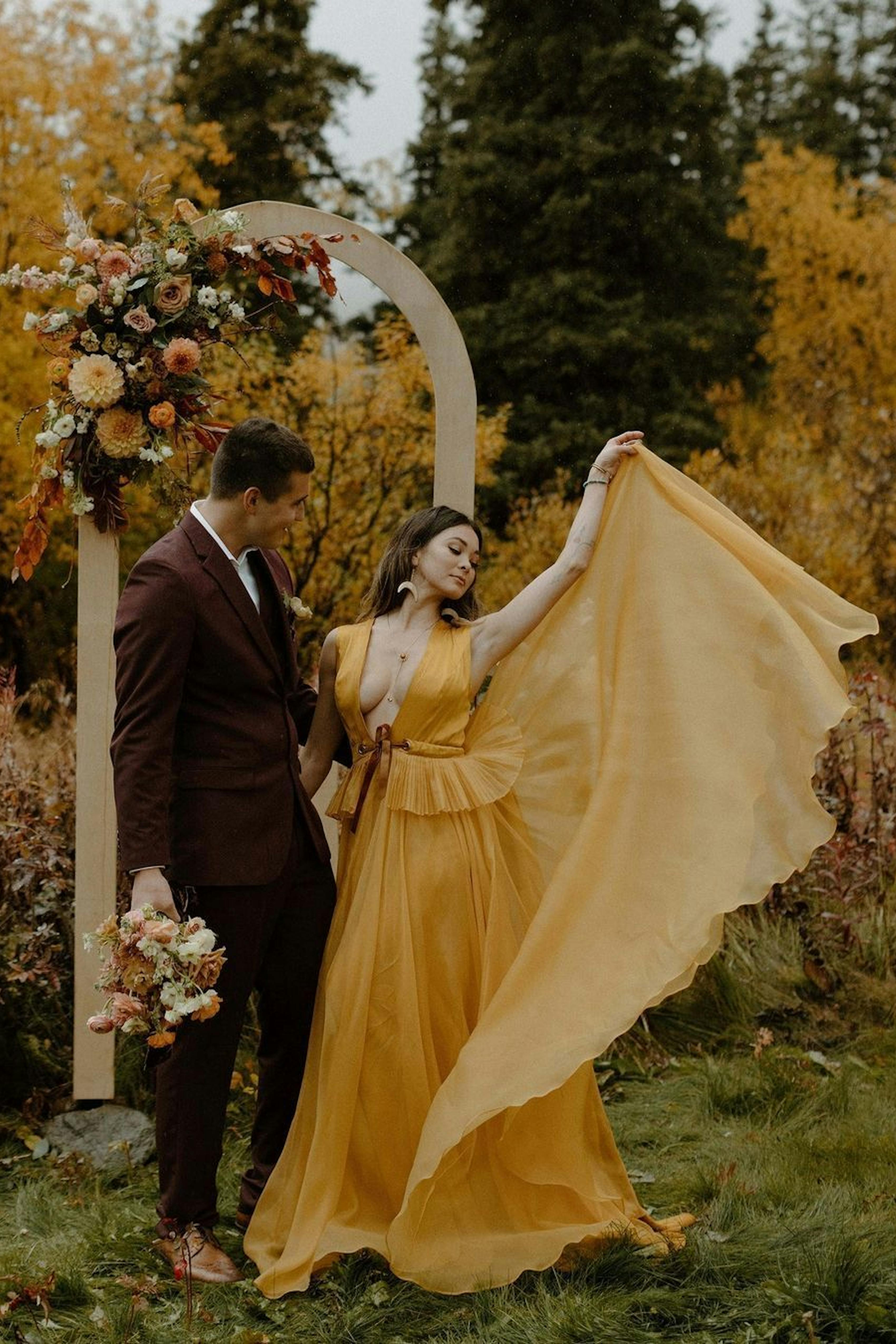 Colorful fall wedding for yellow and red color palette with burgundy groom suit