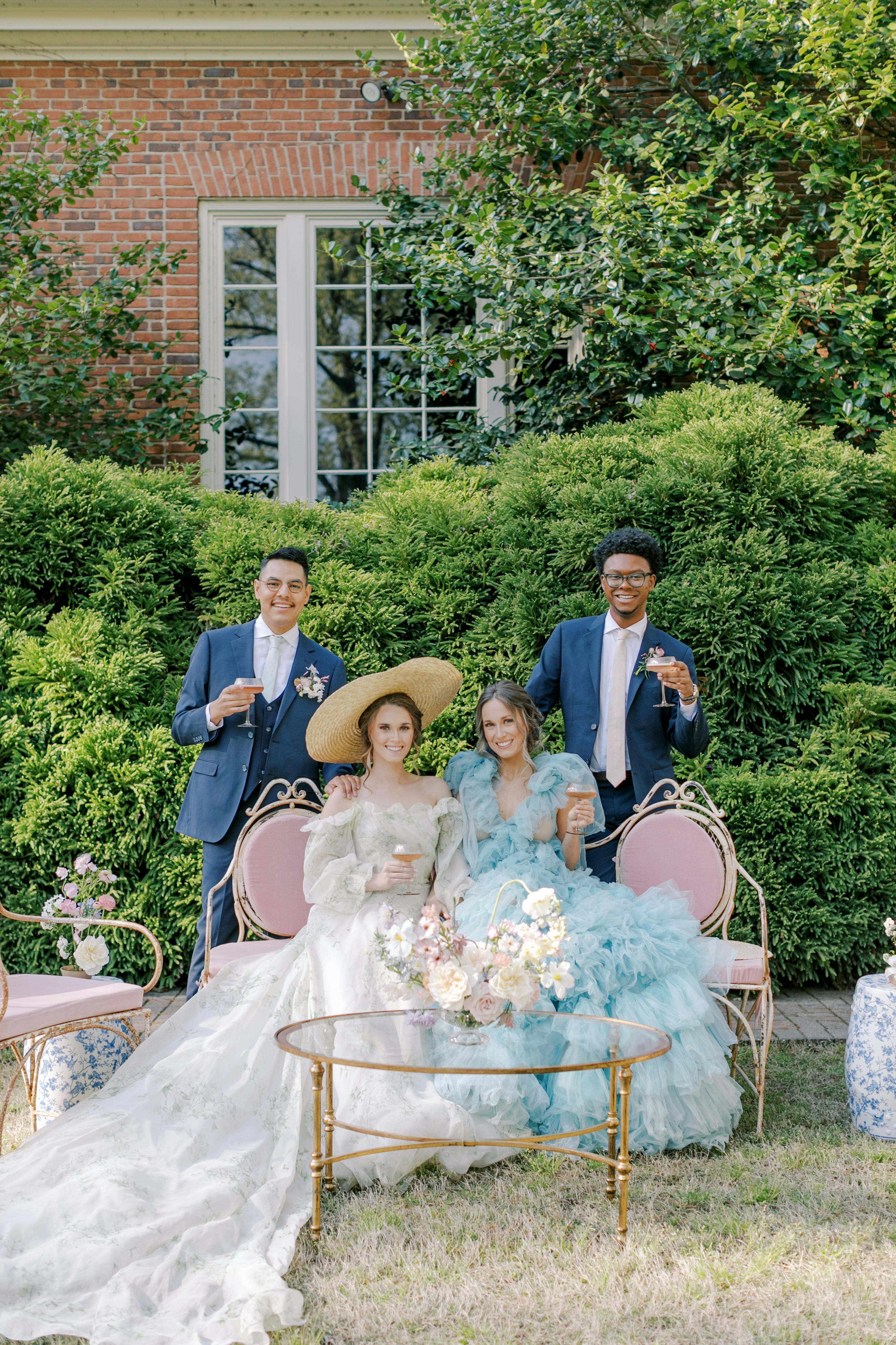 Navy blue groomsman suits with light pink and blue bridesmaid dresses for garden party wedding