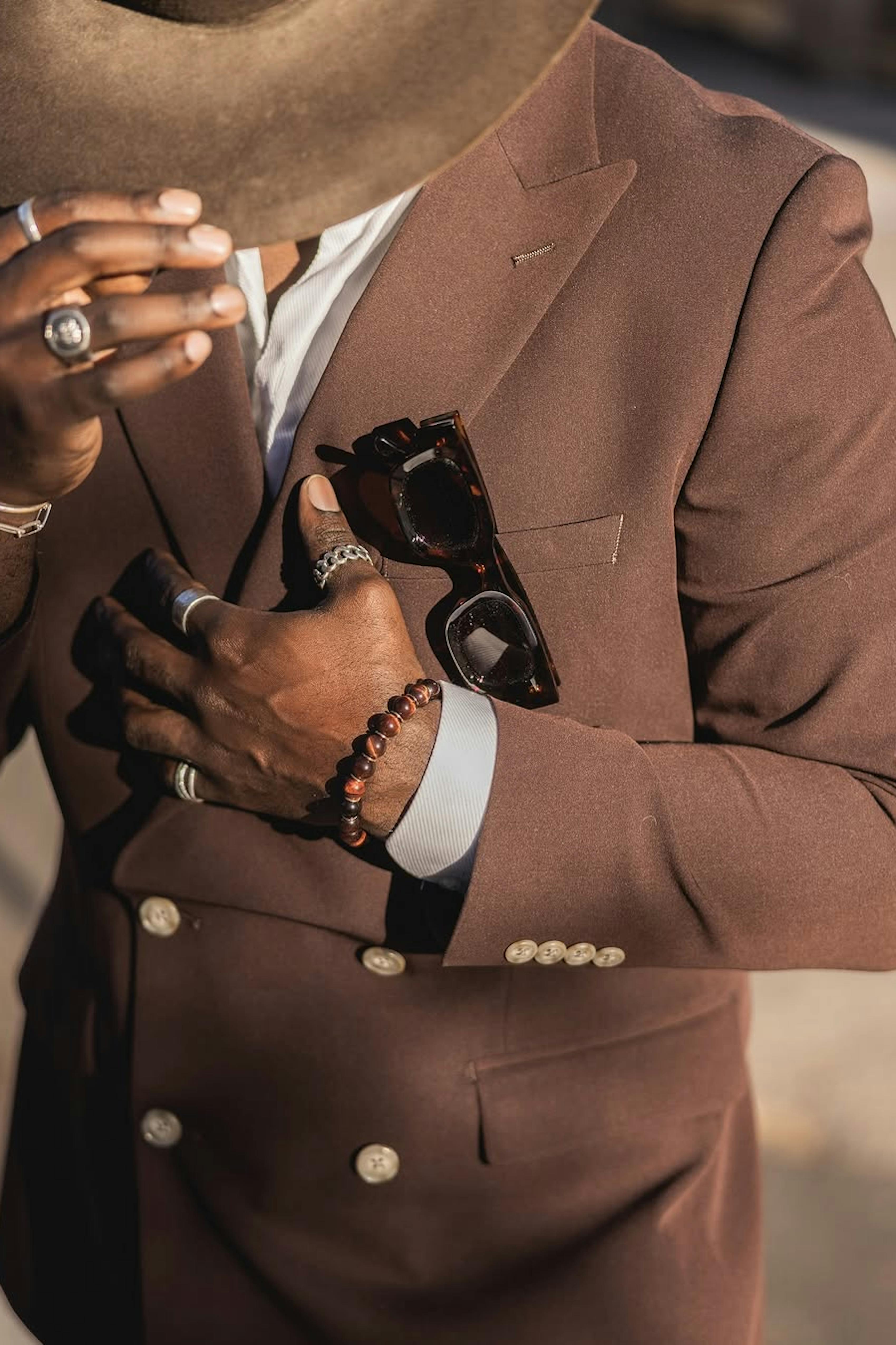 Dark brown double breasted men's suit with accessories