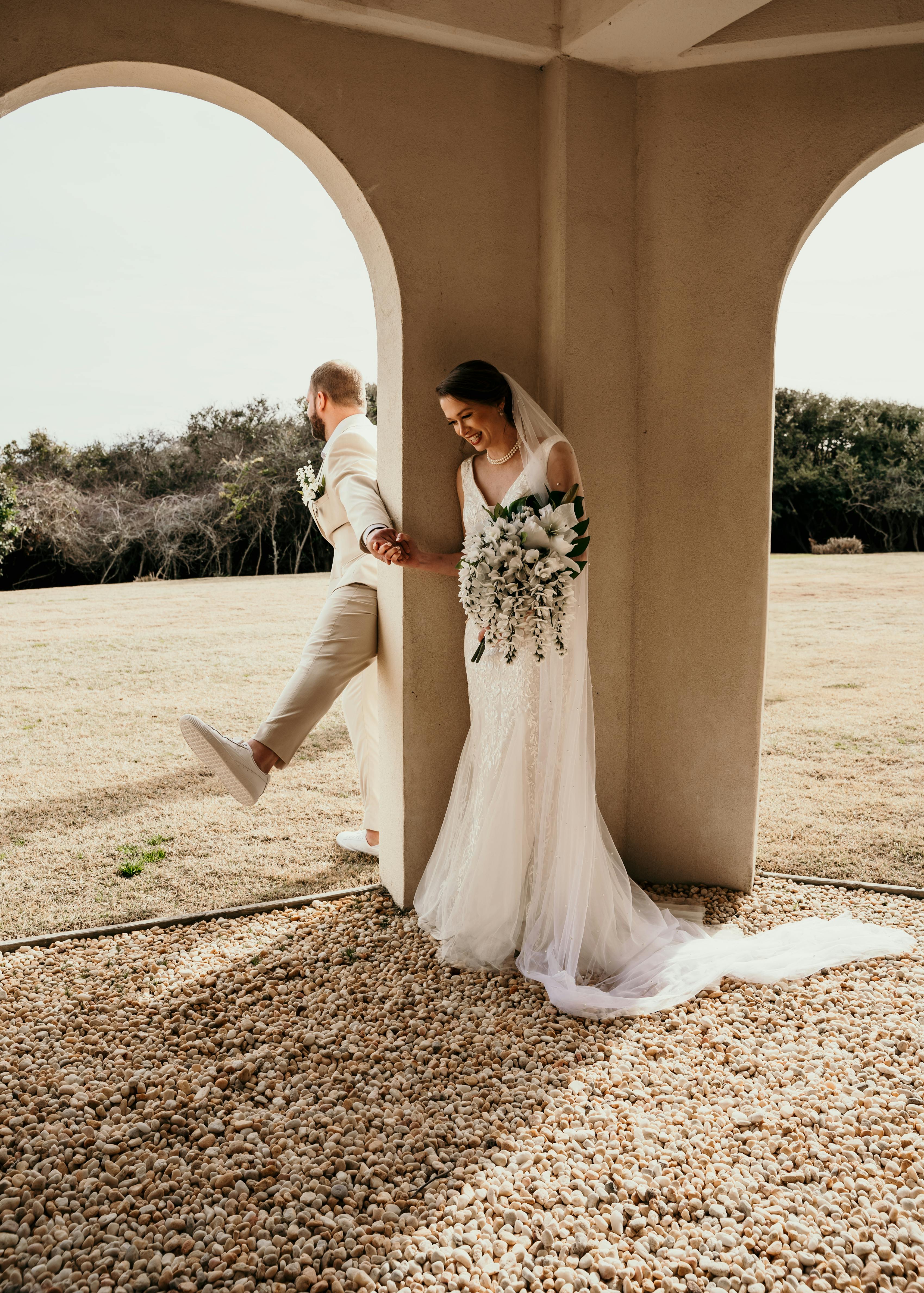 bride and groom have a first touch before their desert wedding ceremony