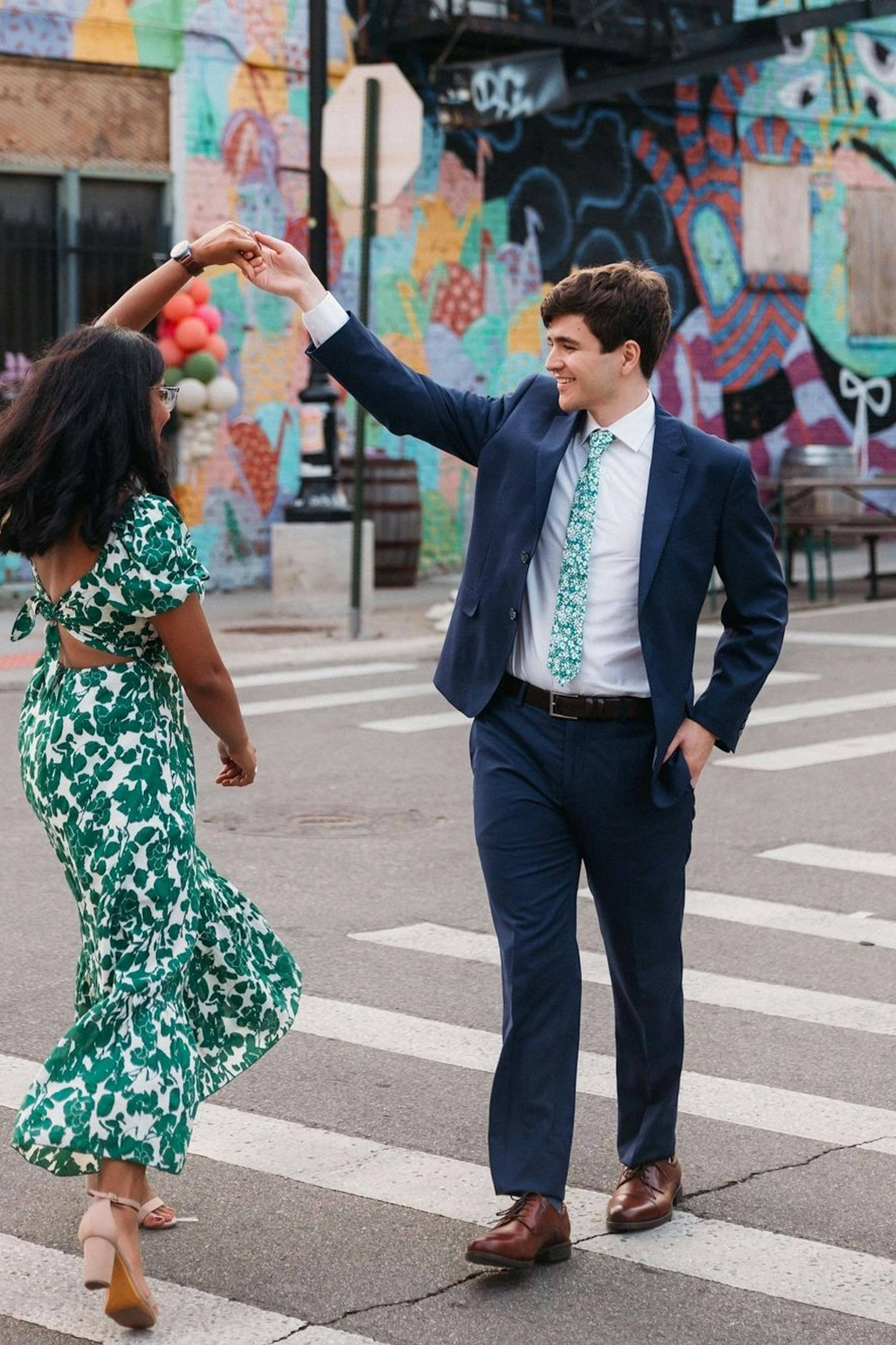 Couple dancing in daytime cocktail outfits for men and women