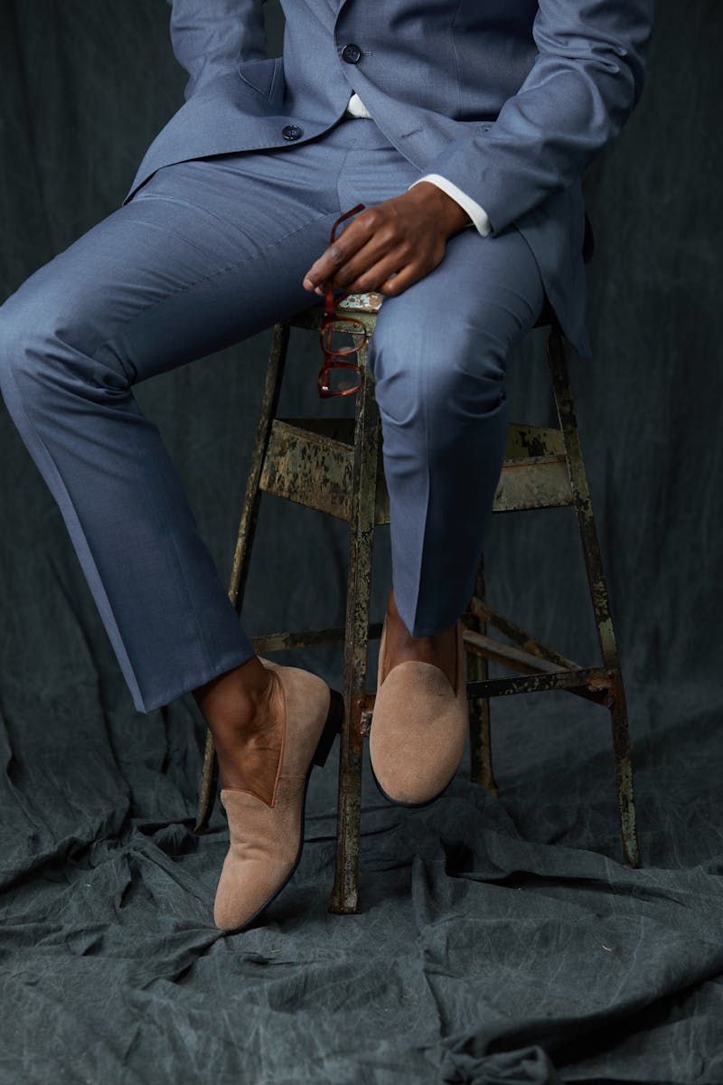 Men's light blue dress pants paired with suede beige loafers