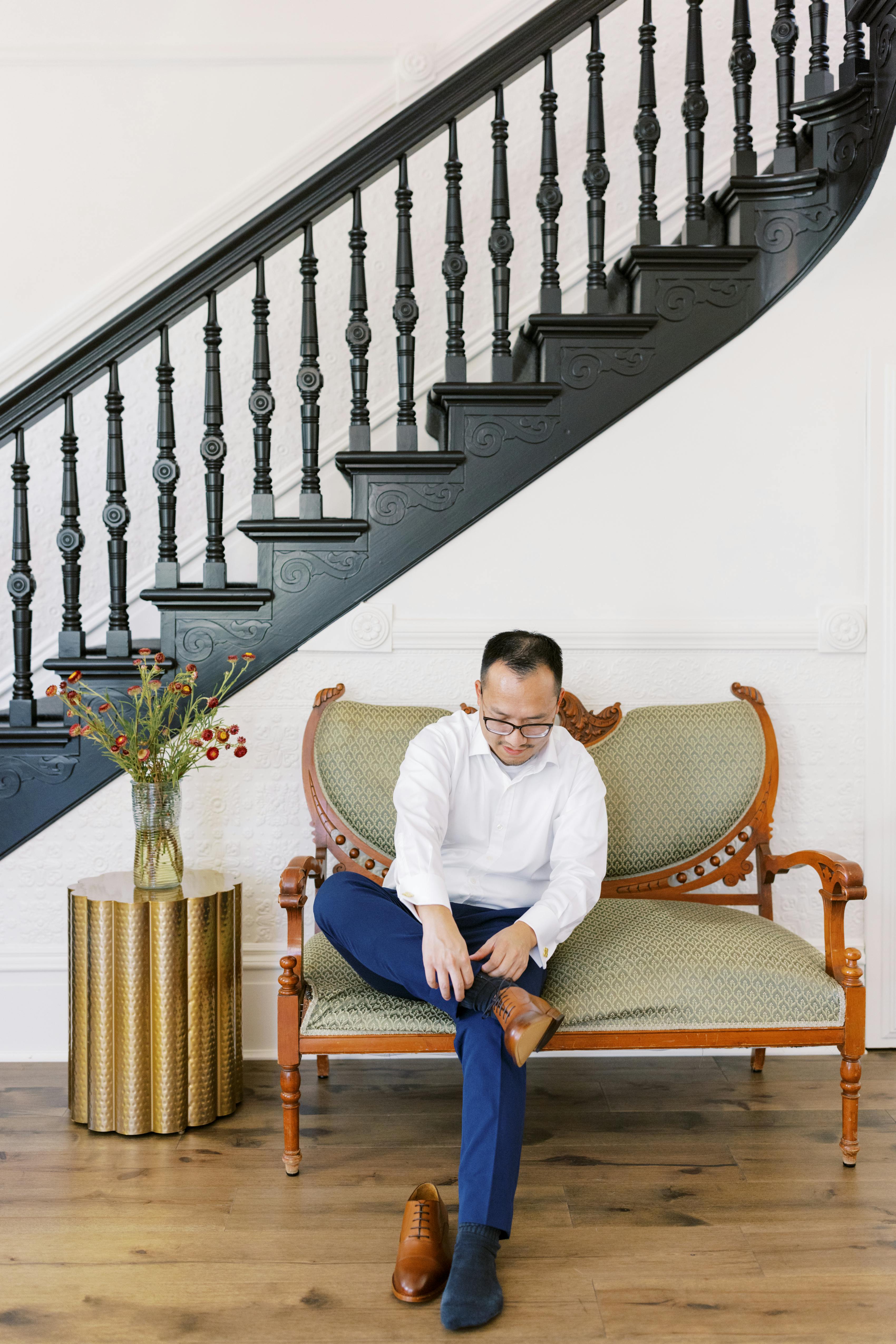 Man in royal blue slacks putting on brown dress does