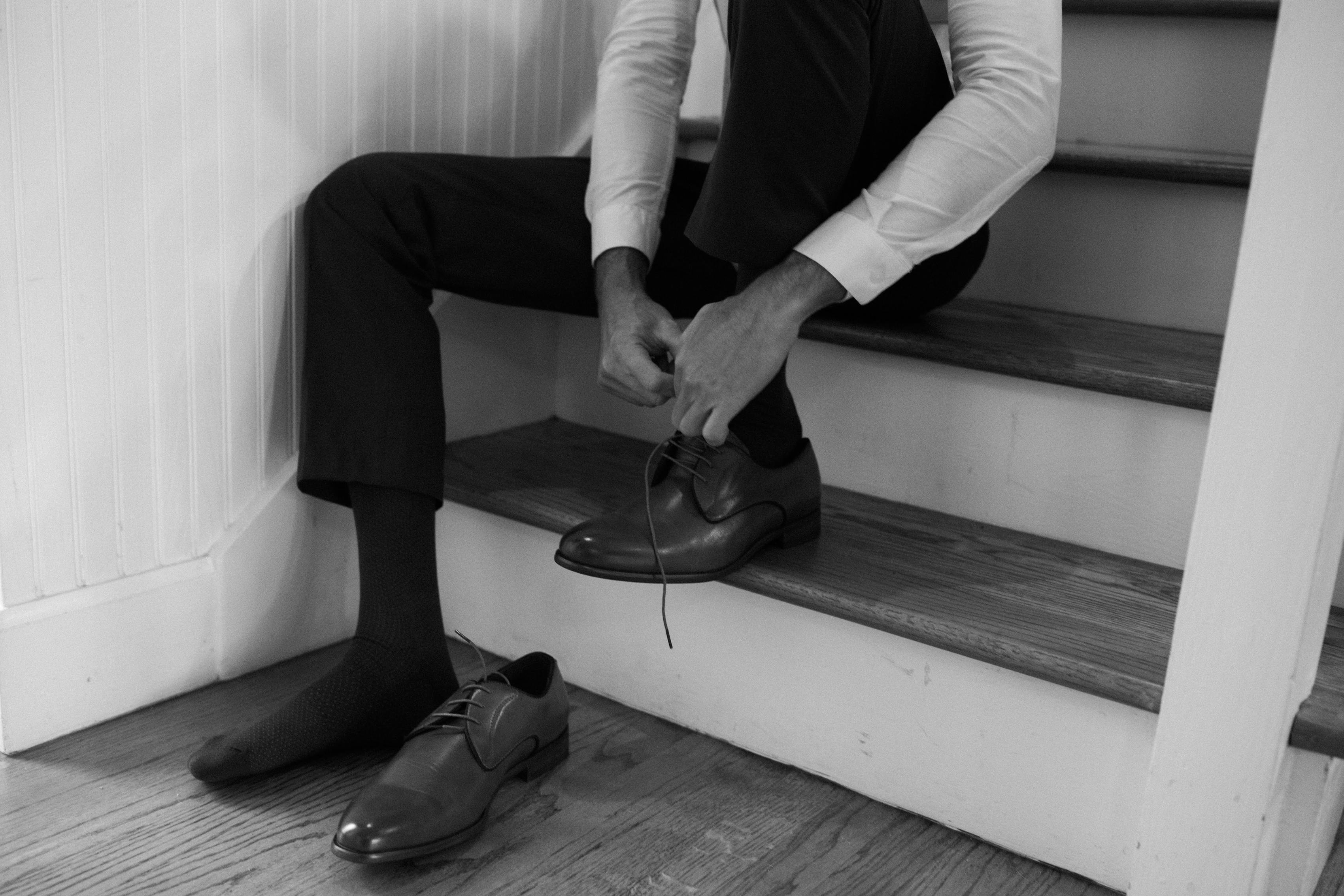 Black slacks with lace-up dress shoes in black and white