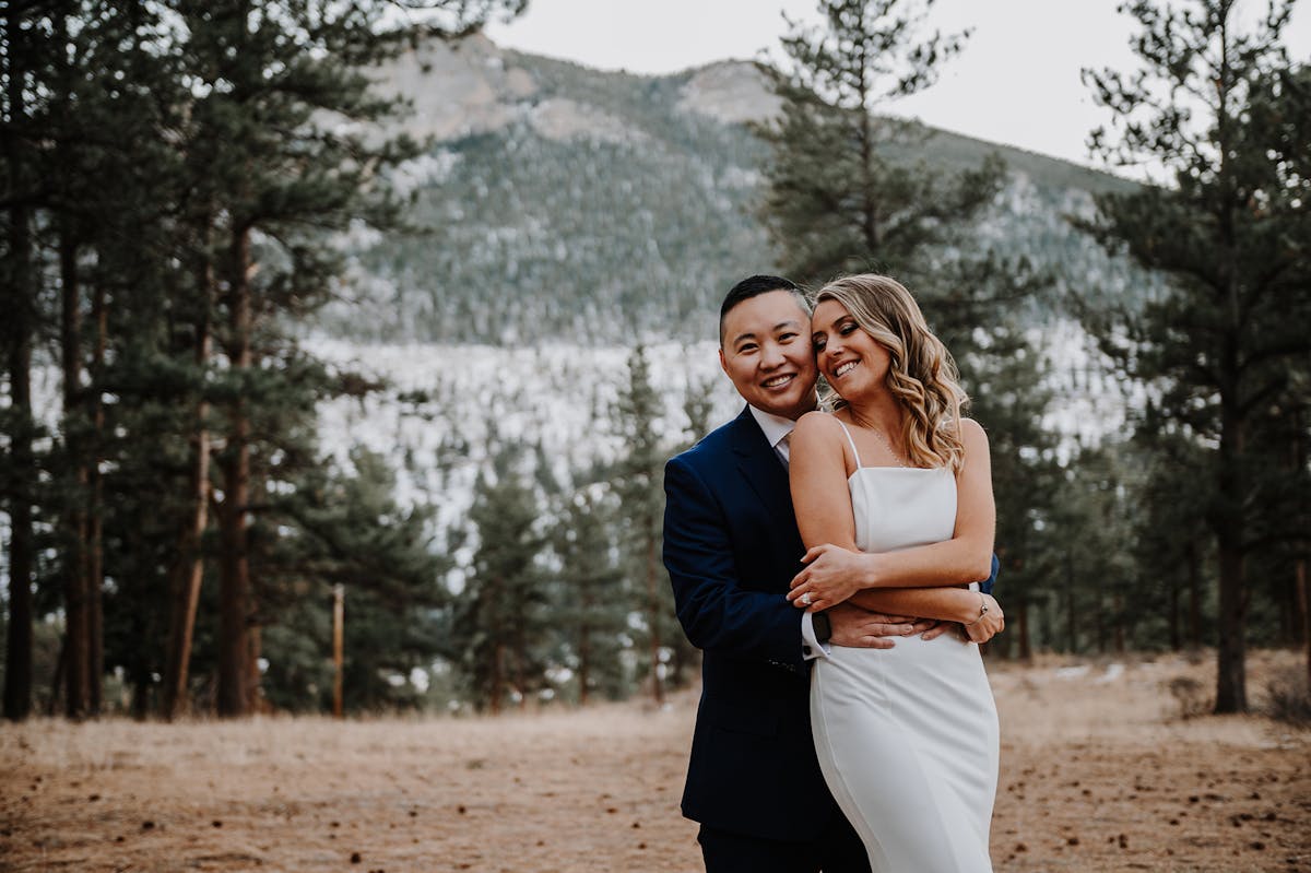 brides pose in rocky mountains for wedding photos 