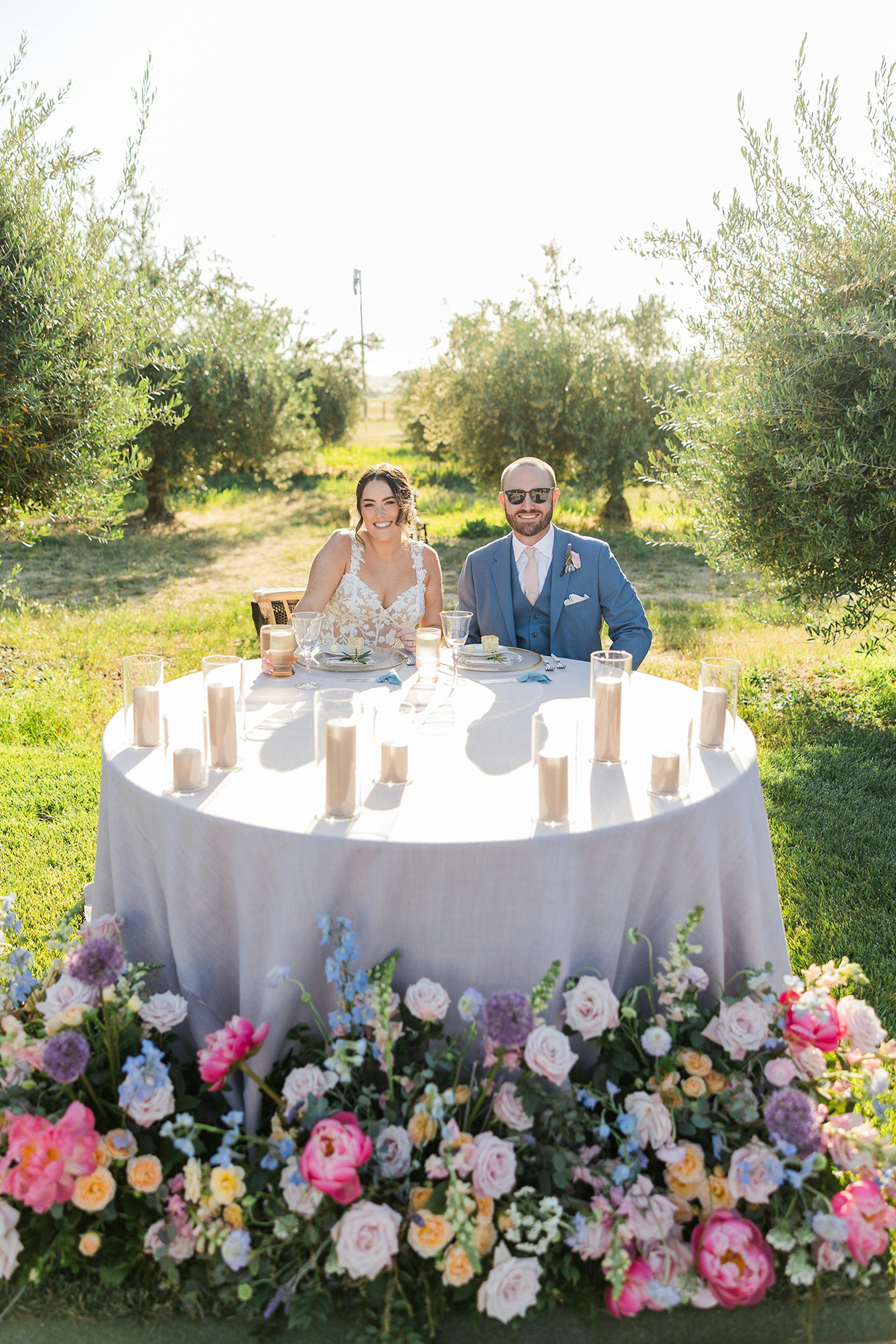 Wedding sweetheart table at an outdoor vineyard wedding.