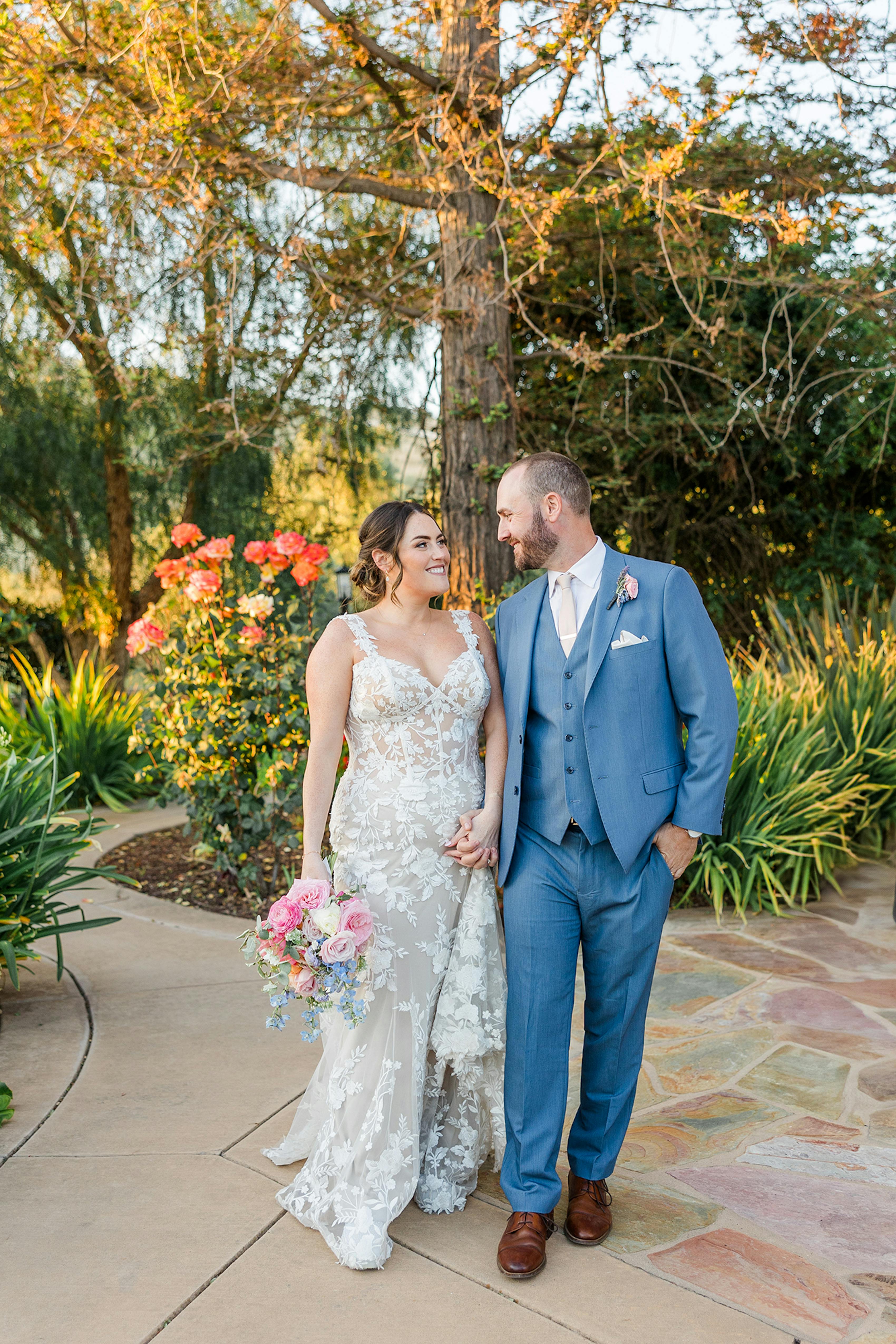California spring wedding attire bride's vintage inspired lace dress and groom's three piece blue suit.