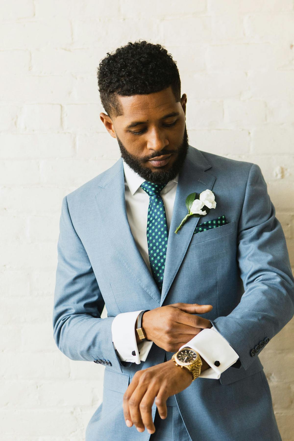 Groom outfit for beach wedding with light blue suit, colorful patterned tie and pocket square