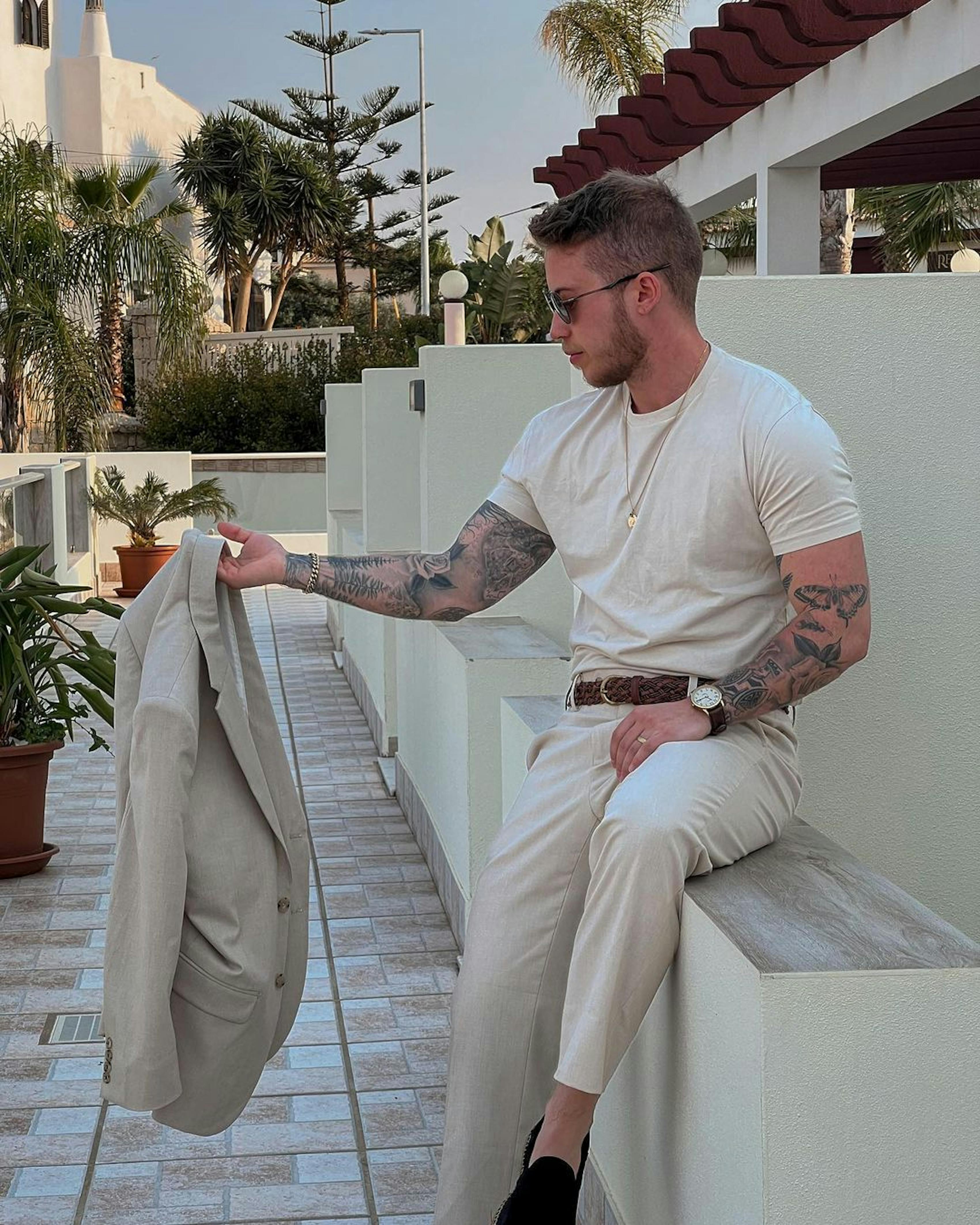 Beach wedding guest outfit with monochrome tan suit and brown accessories