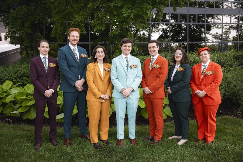 Mix gender wedding party in bold, colorful suits for men and women