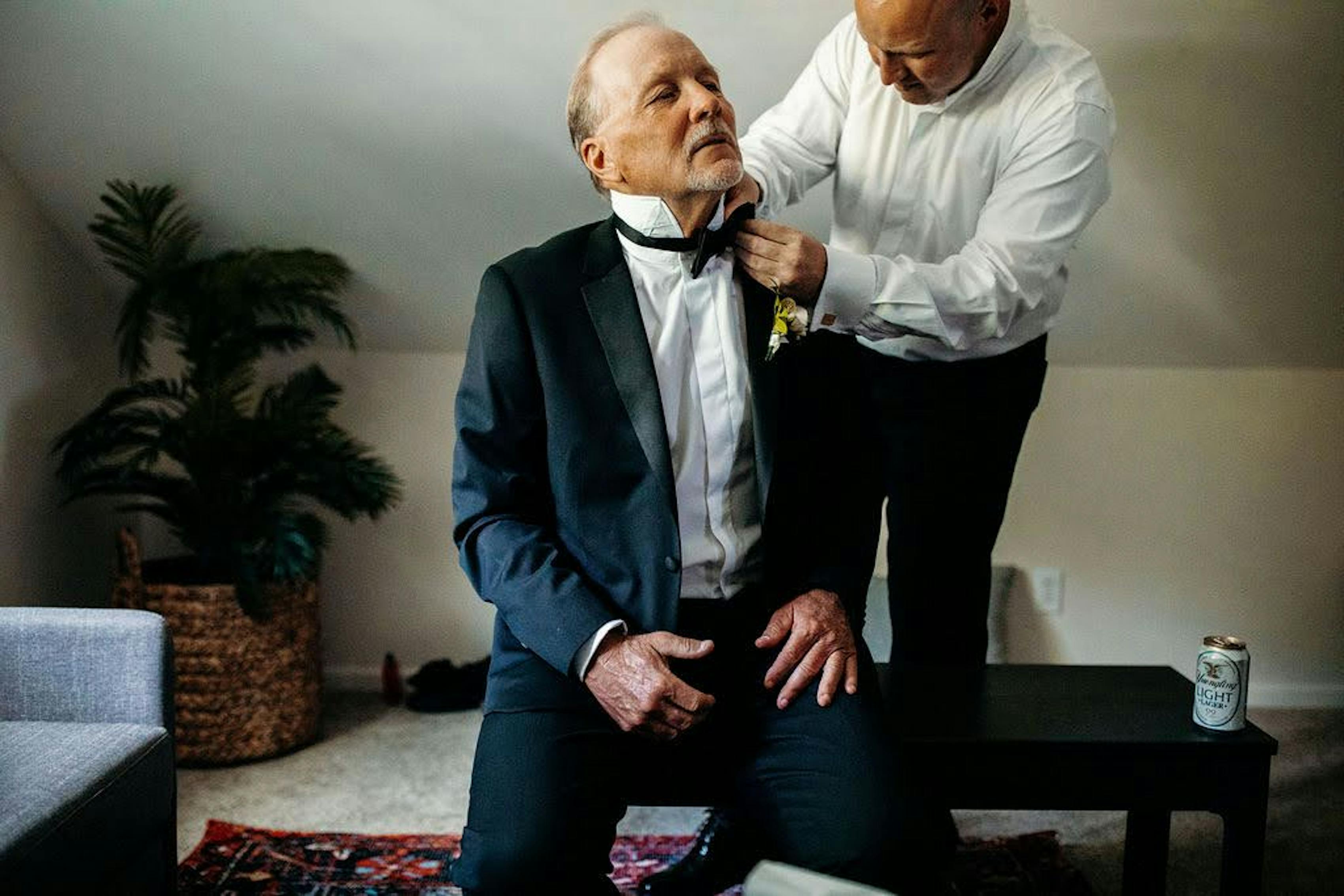 Getting ready in father of the groom tuxedo as a black tie wedding outfit for parents