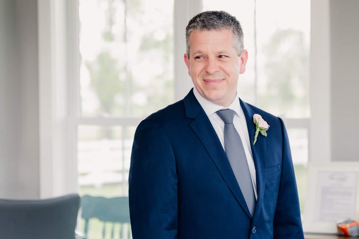 Simple dark royal blue father of the bride or groom suit with gray suit accessories