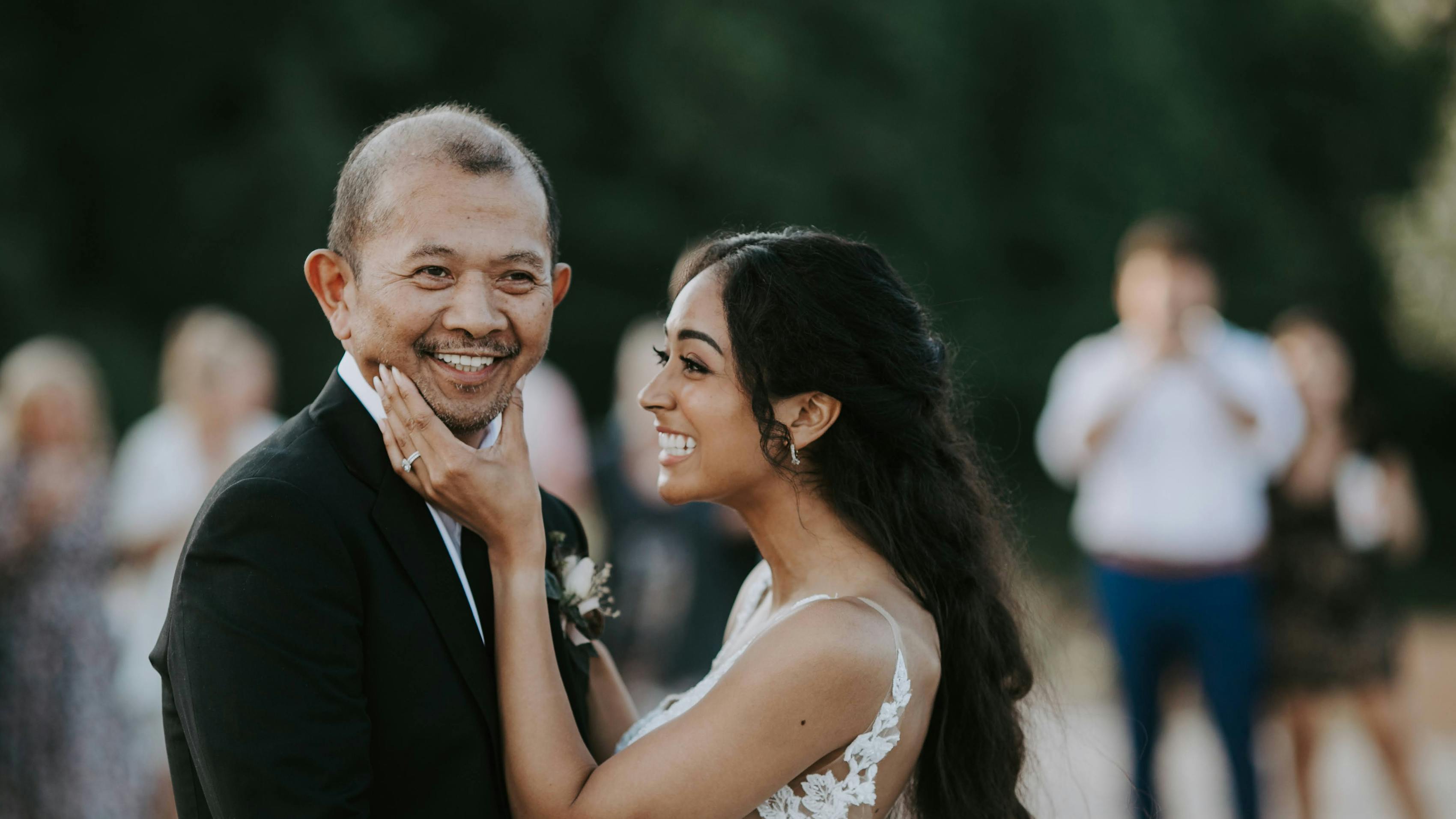 Father wearing classic black wedding suit to walk bride down the aisle