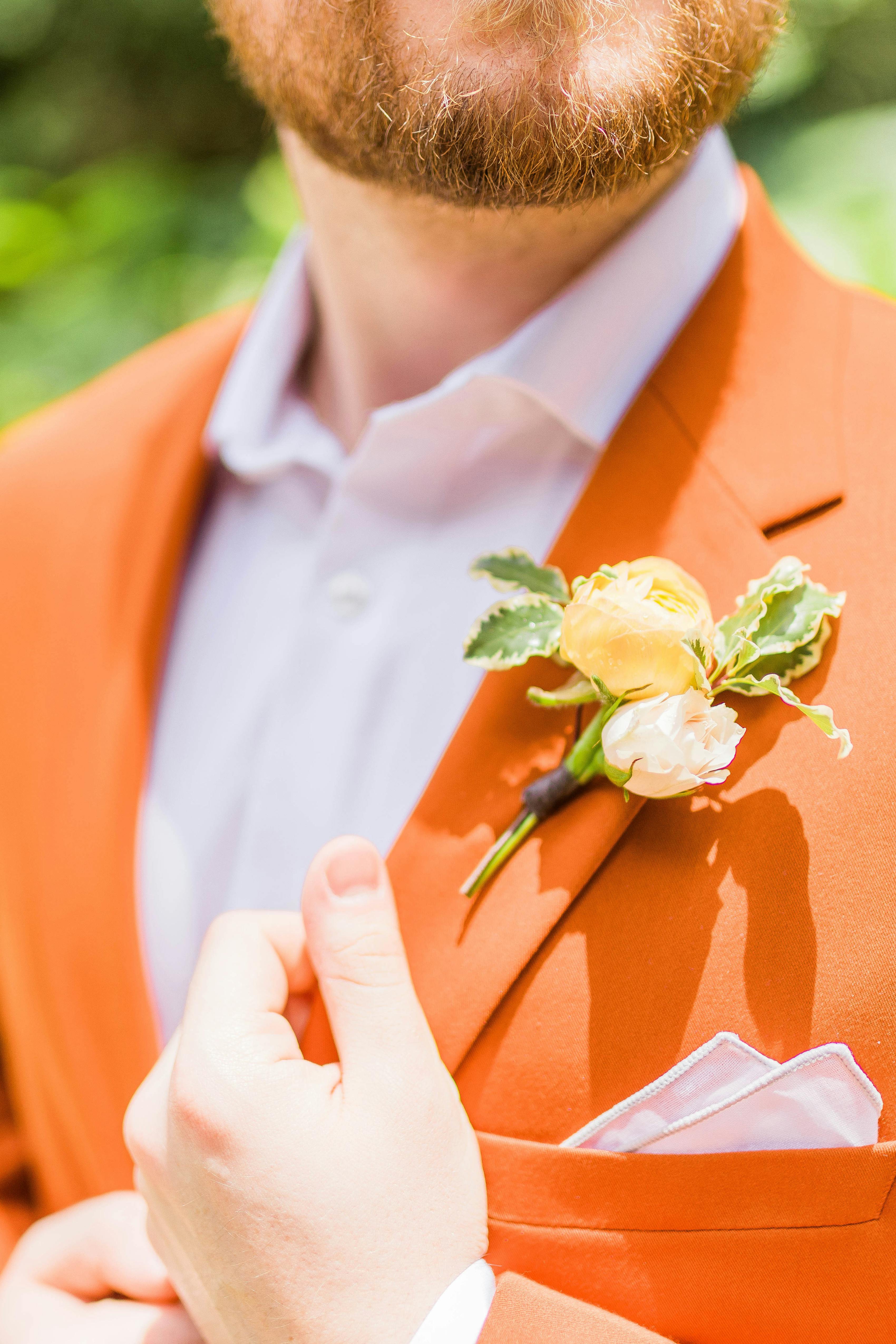 Rust suit color with simple white accessories