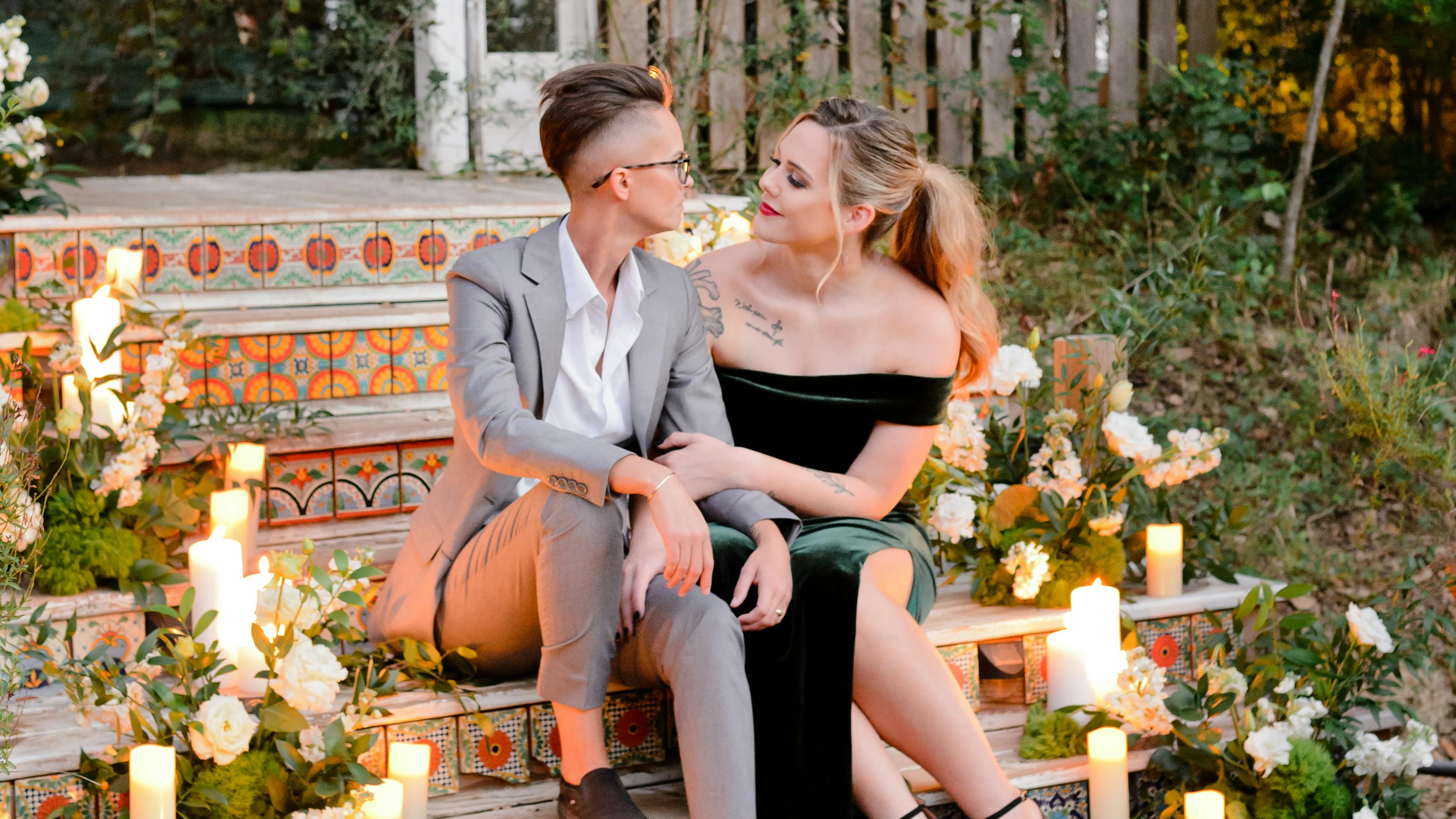 Couple wearing light grey suit and green velvet dress for fall outdoor wedding