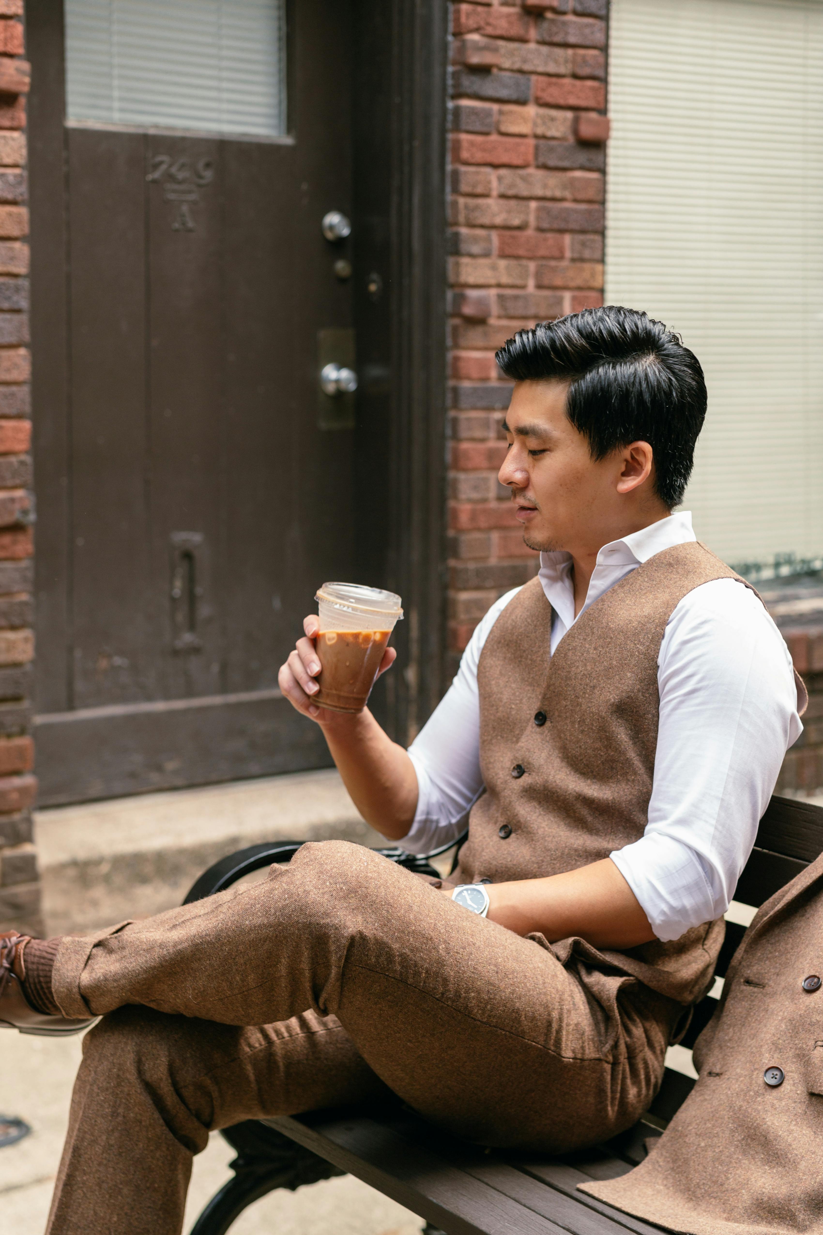 Man at cafe wearing cool casual tweed outfit for trendy men's fashion.