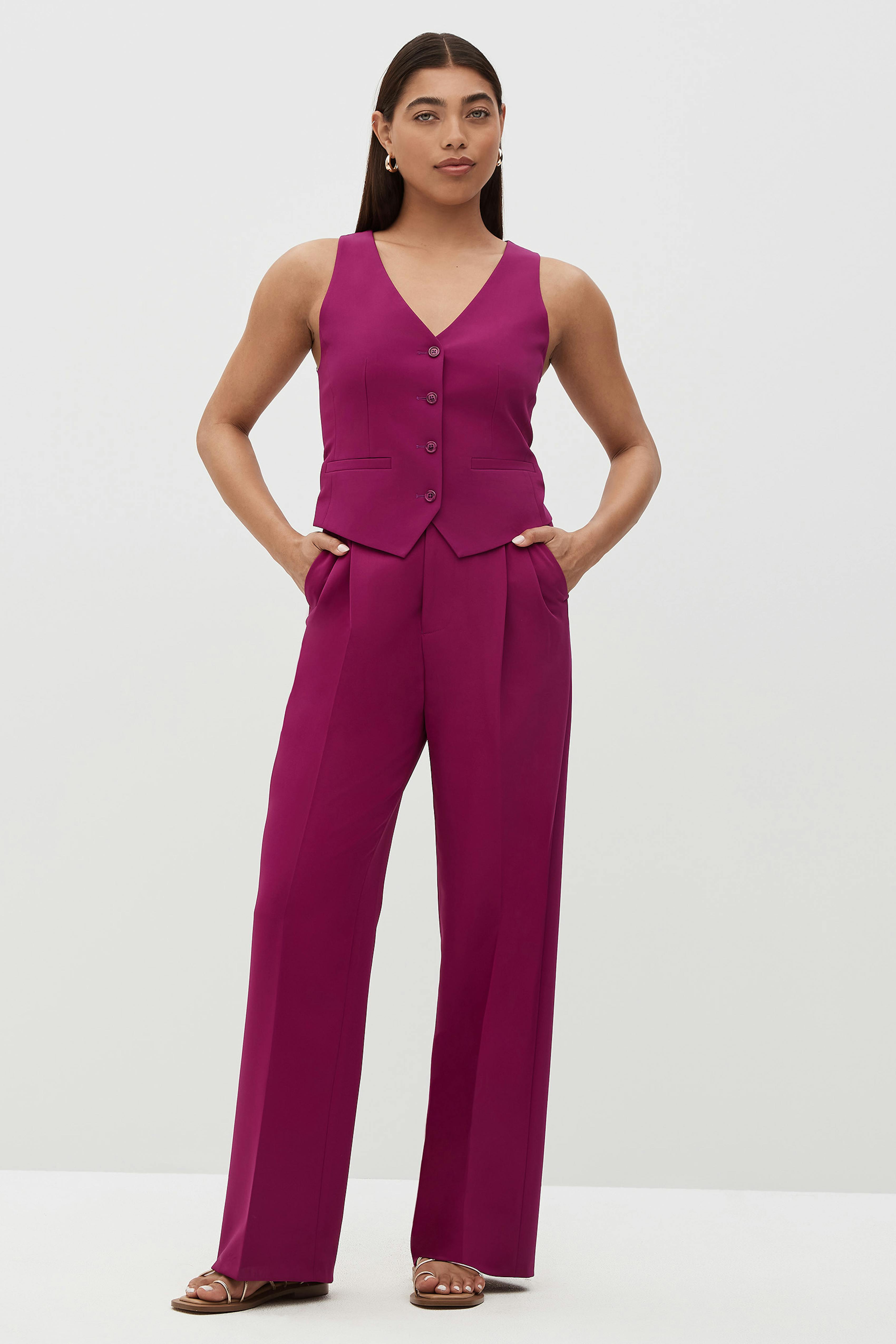 Women's fuchsia pant suit with a vest.