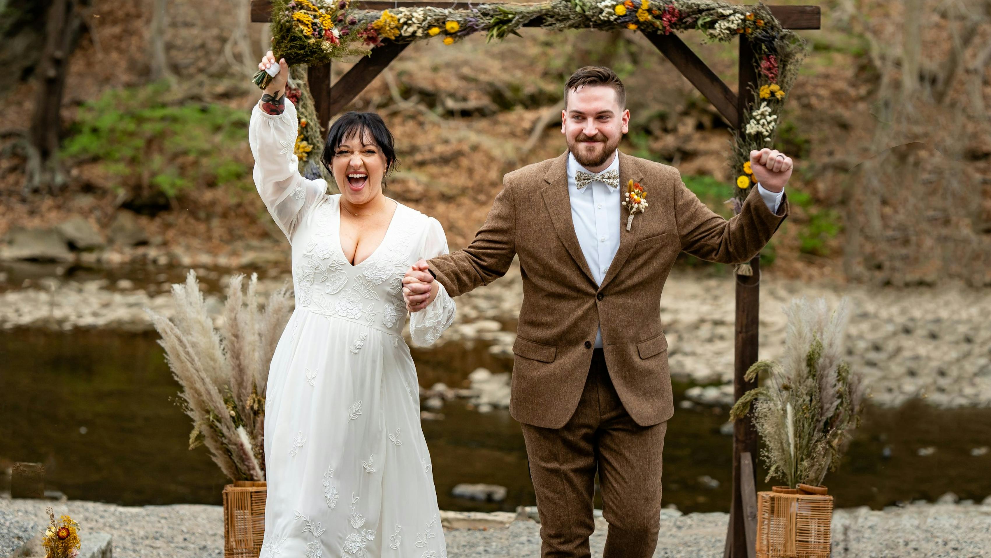 Groom wearing Dark Brown Tweed Suit with earthy accessories at a fall wedding