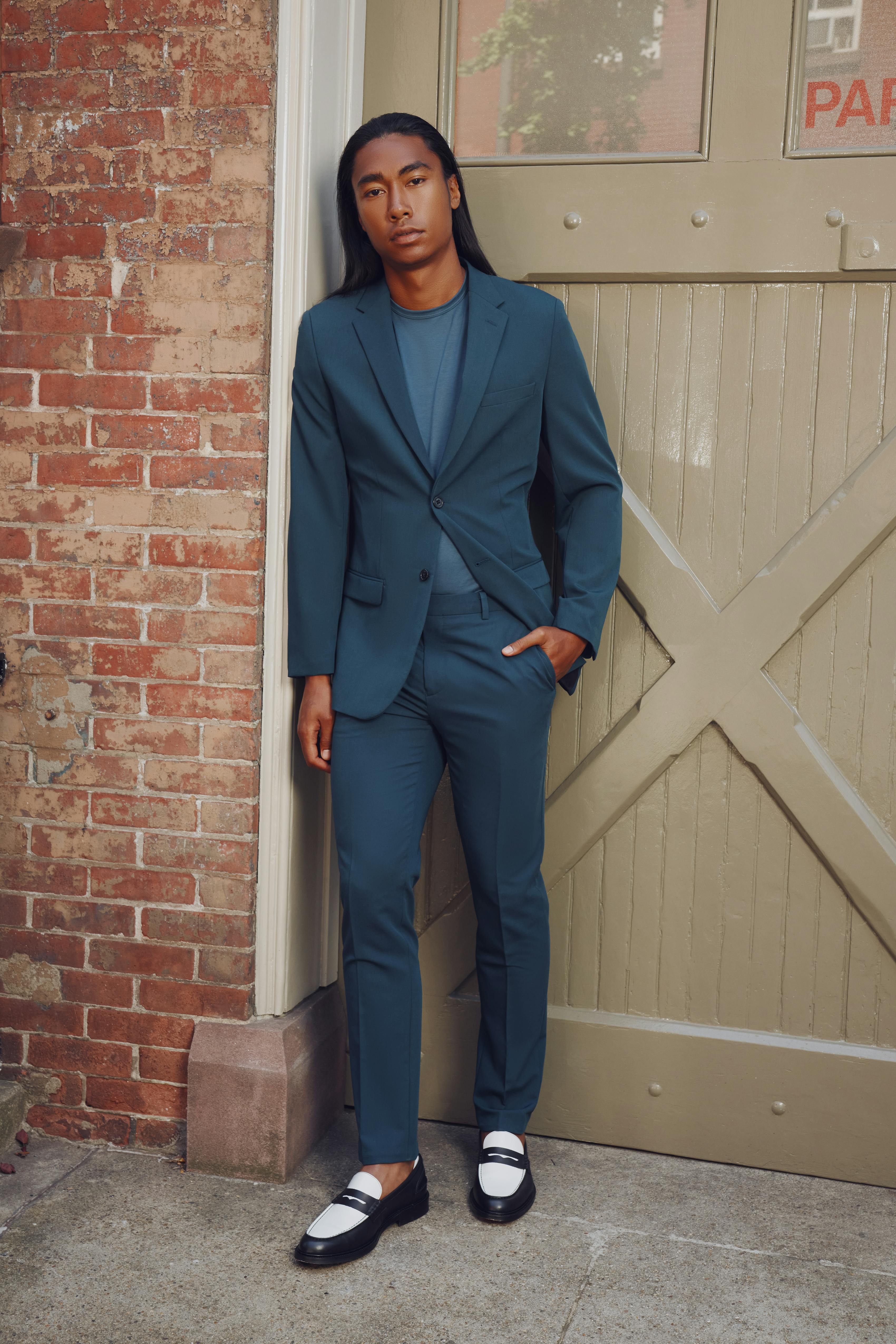 Men wearing teal suit on city street for menswear style or special event