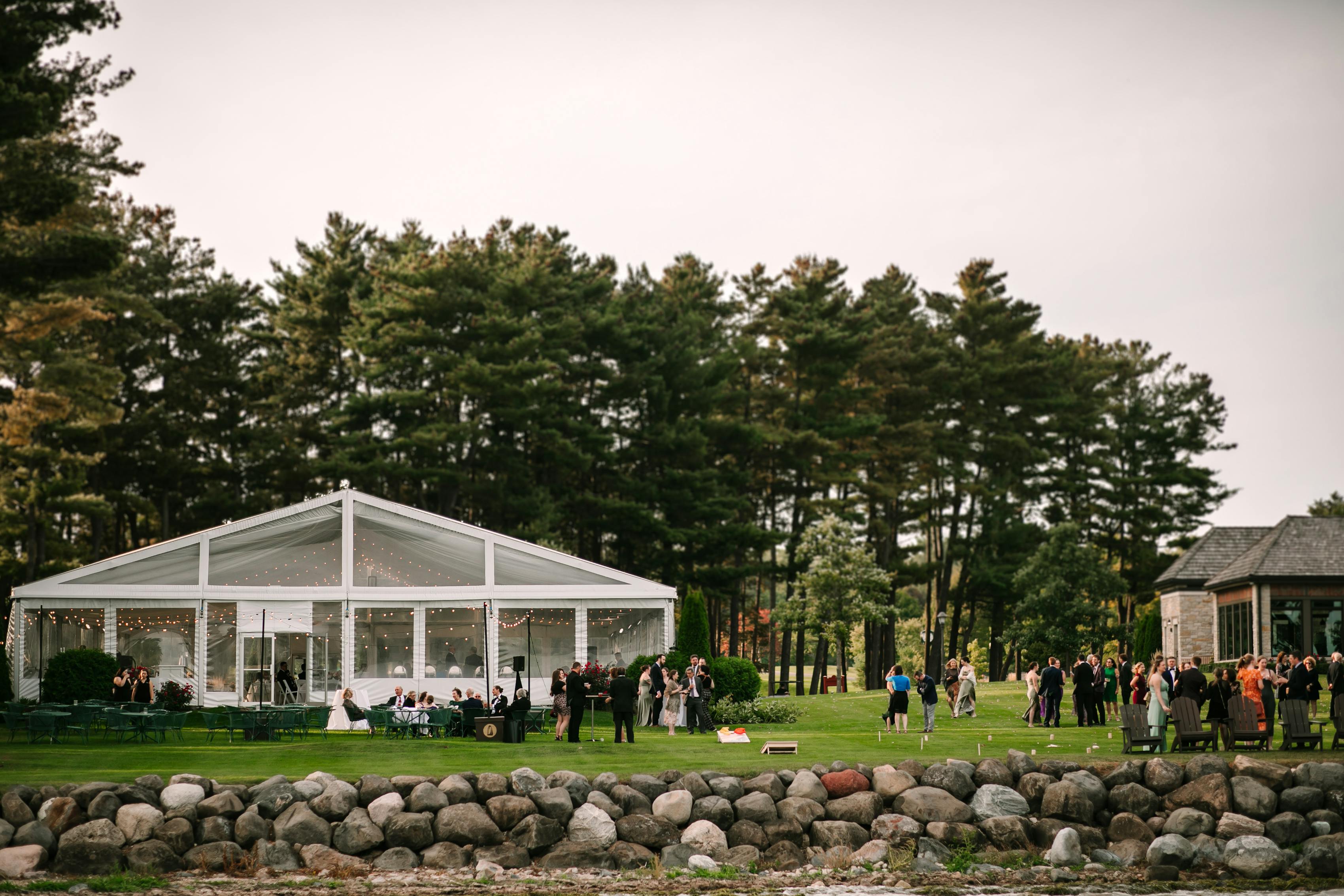Clear outdoor tent reception for a lakeside wedding reception in Wisconsin.