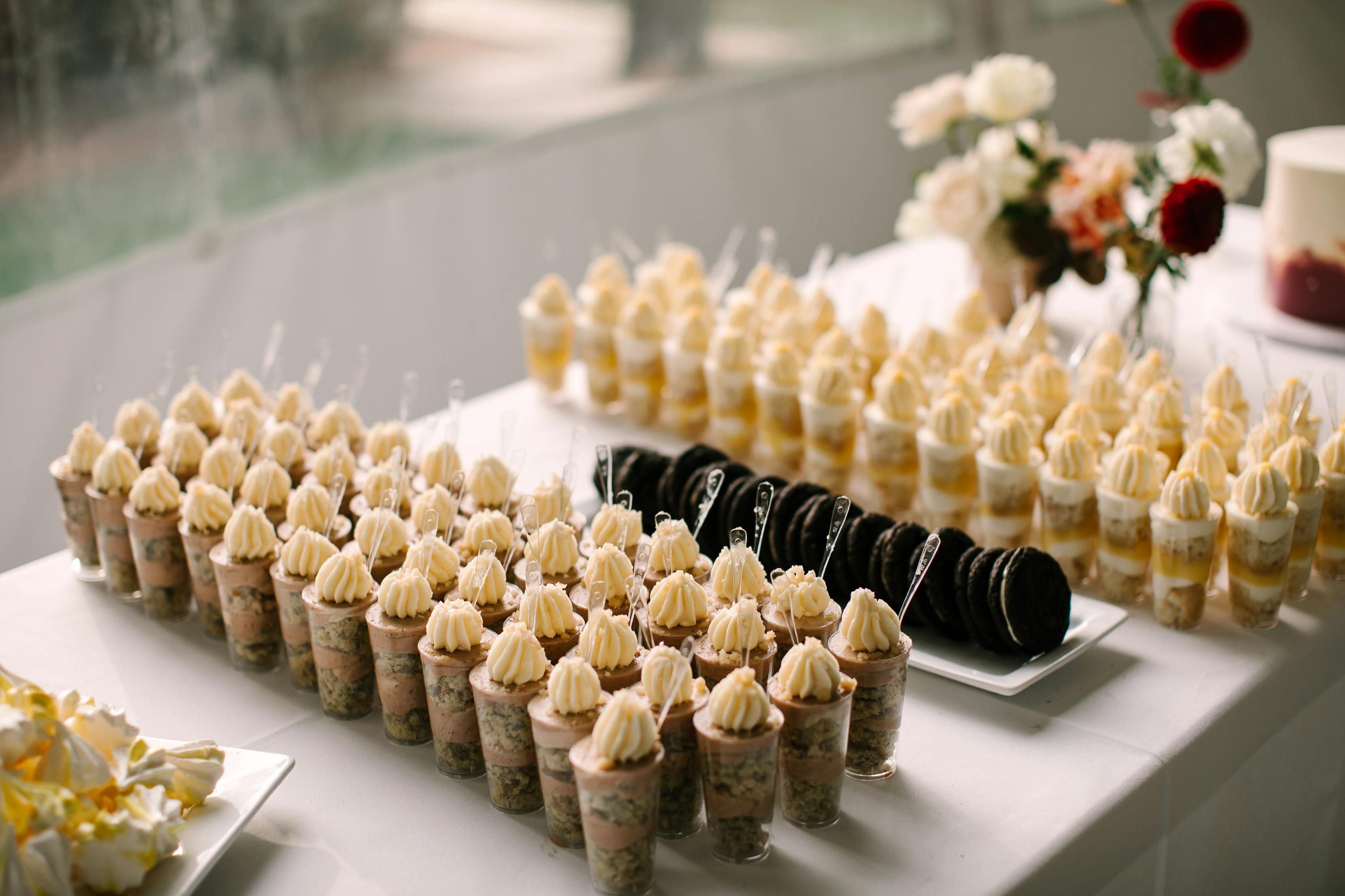 Custom wedding dessert table with parfaits and cookies.