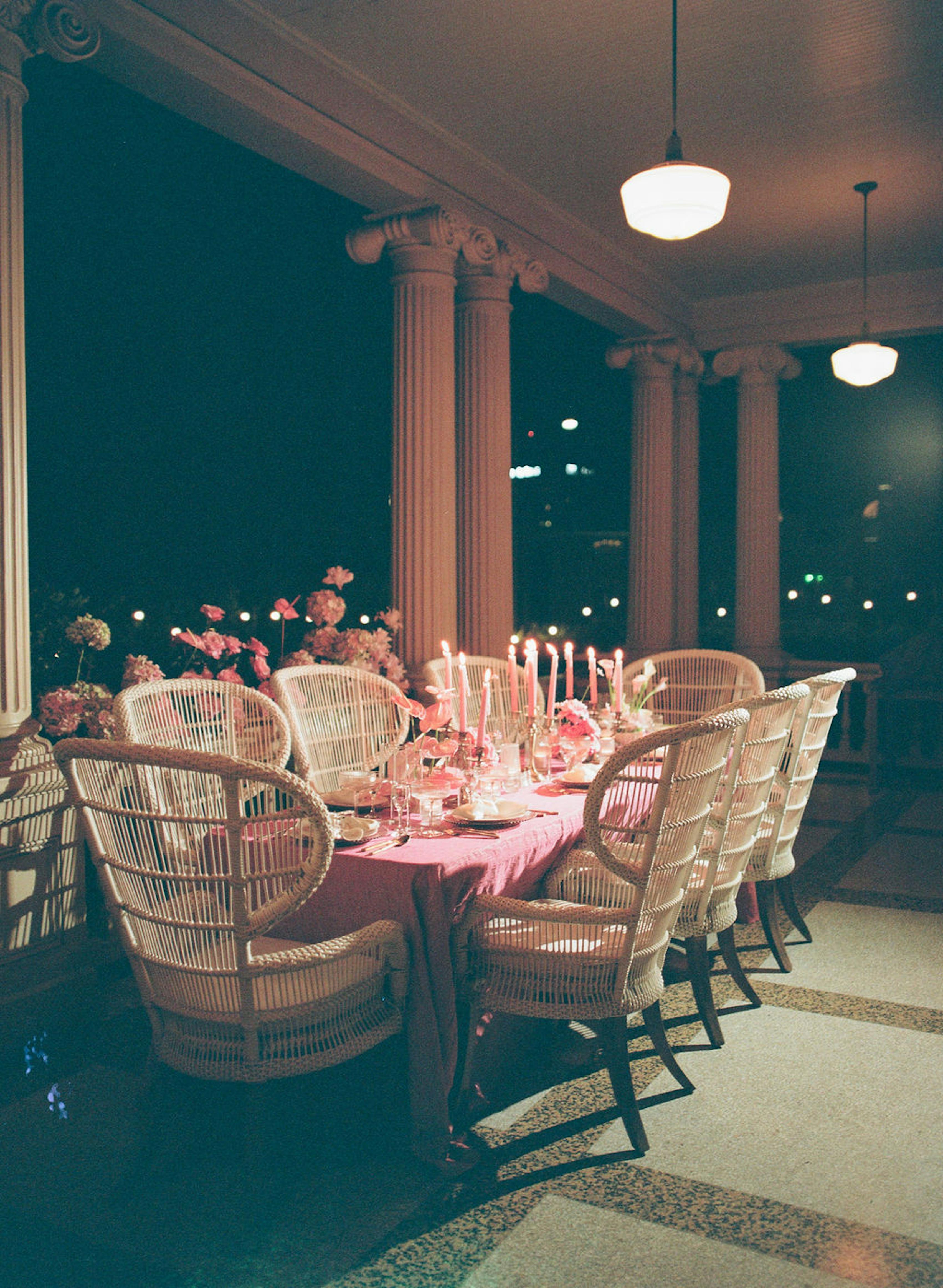 Pink wedding reception table decor with pink tablecloths and candlesticks
